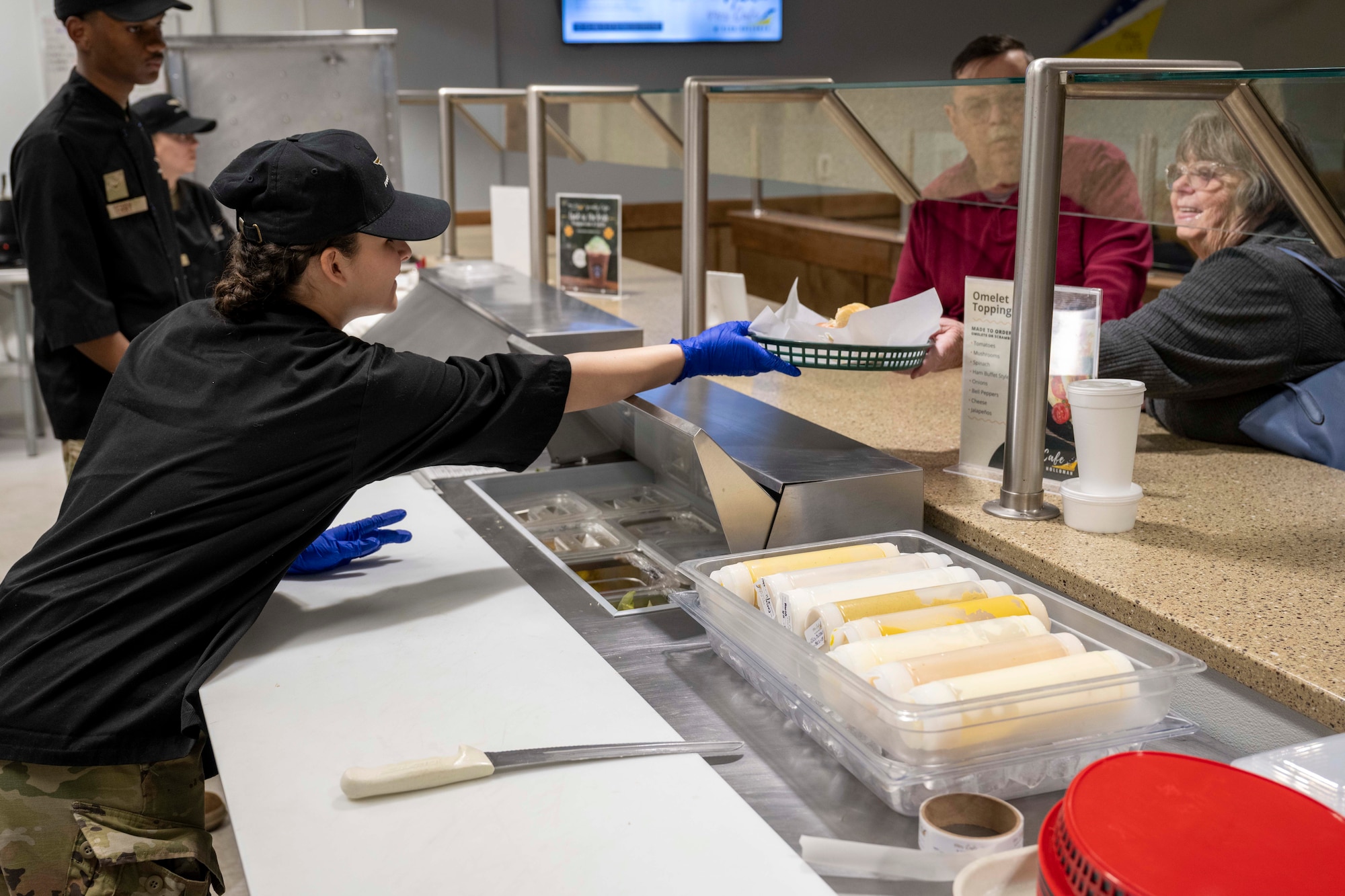 An Airman from the 49th Support Support Squadron serves lunch at Holloman Air Force Base, New Mexico, March 27, 2024. The 49er Cafe recently unveiled a new menu featuring a selection of delectable breakfast and lunch items, along with coffee drinks for base personnel. (U.S. Air Force photo by Airman 1st Class Michelle Ferrari)