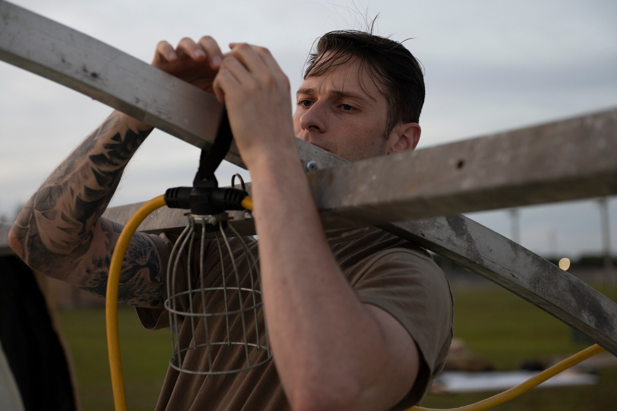 U.S. Air Force Staff Sgt. Travis Cain, 23rd Munitions Squadron conventional maintenance crew chief, assembles a light on a shelter for exercise Ready Tiger 24-1 at Avon Park Air Force Range, Florida, April 8, 2024. Airmen from various specialties assisted the 23rd Civil Engineer Squadron to assemble the shelters. During Ready Tiger 24-1, the 23rd Wing will be evaluated on the integration of Air Force Force Generation principles such as Agile Combat Employment, integrated combat turns, forward aerial refueling points, multi-capable Airmen, and combat search and rescue capabilities. (U.S. Air Force photo by Senior Airman Rachel Coates)