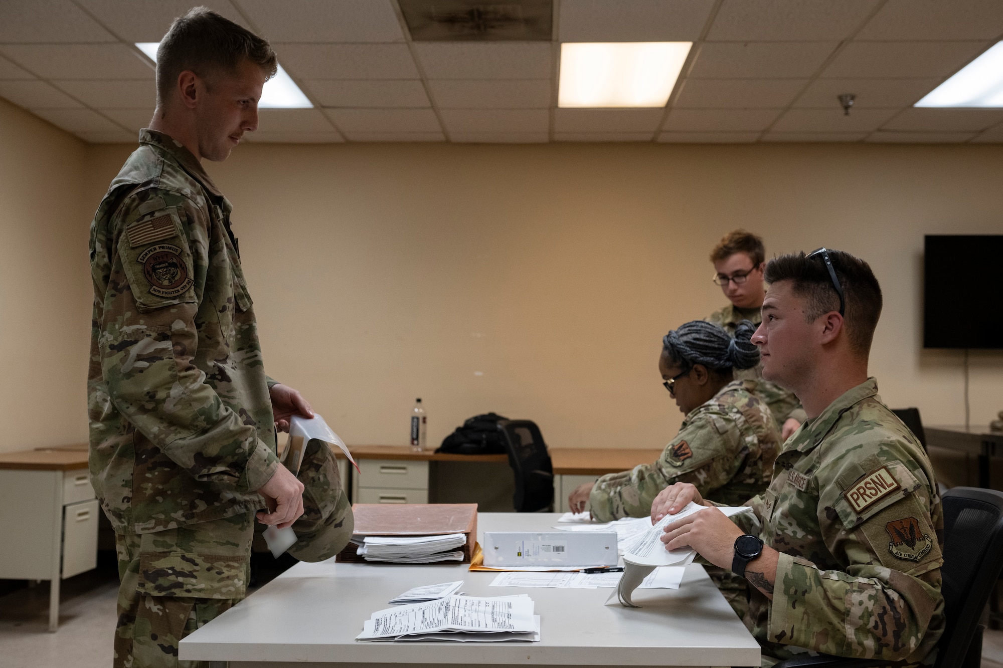 U.S. Air Force Senior Airman Christopher Elrod, 23rd Force Support Squadron personnel support for contingency operations, right, in-processes Senior Airman Nathaniel Steele, 74th Fighter Generation Squadron weapons load crew member for exercise Ready Tiger 24-1 at Avon Park Air Force Range, Florida, April 8, 2024. The PERSCO team provided accurate and timely information for troop movements while overseeing personnel logistics during deployments. Ready Tiger 24-1 is a readiness exercise demonstrating the 23rd Wing’s ability to plan, prepare and execute operations and maintenance to project air power in contested and dispersed locations, defending the United States’ interests and allies. (U.S. Air Force photo by Senior Airman Rachel Coates)