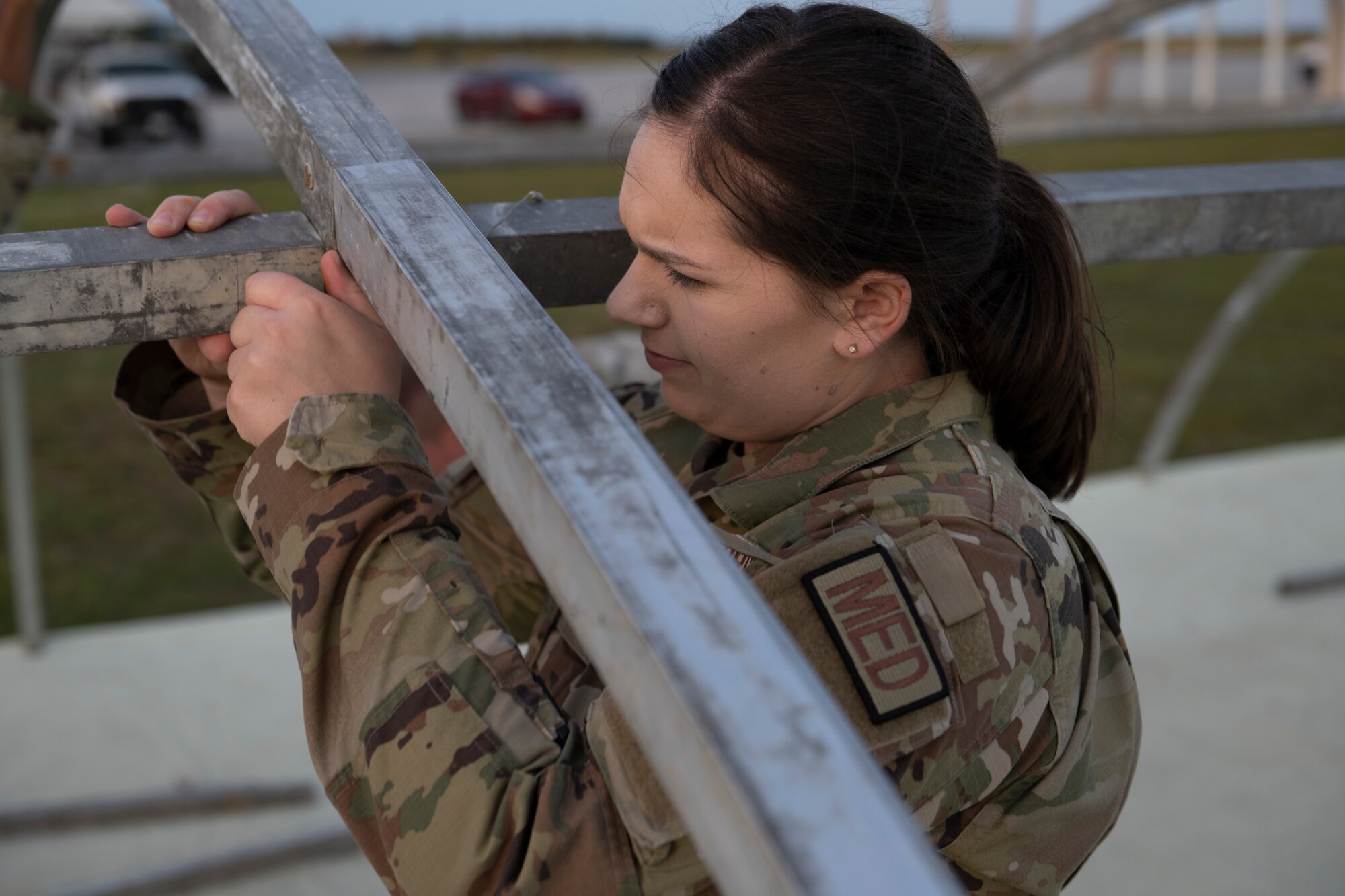 U.S. Air Force Airman 1st Class Rachel Rouland, 23rd Medical Group medic, assembles a shelter for exercise Ready Tiger 24-1 at Avon Park Air Force Range, Florida, April 8, 2024. Although Rouland is assigned to medical, she takes on a multi-capable Airmen role while in a forward operating site. During Ready Tiger 24-1, the 23rd Wing will be evaluated on the integration of Air Force Force Generation principles such as Agile Combat Employment, integrated combat turns, forward aerial refueling points, multi-capable Airmen, and combat search and rescue capabilities. (U.S. Air Force photo by Senior Airman Rachel Coates)