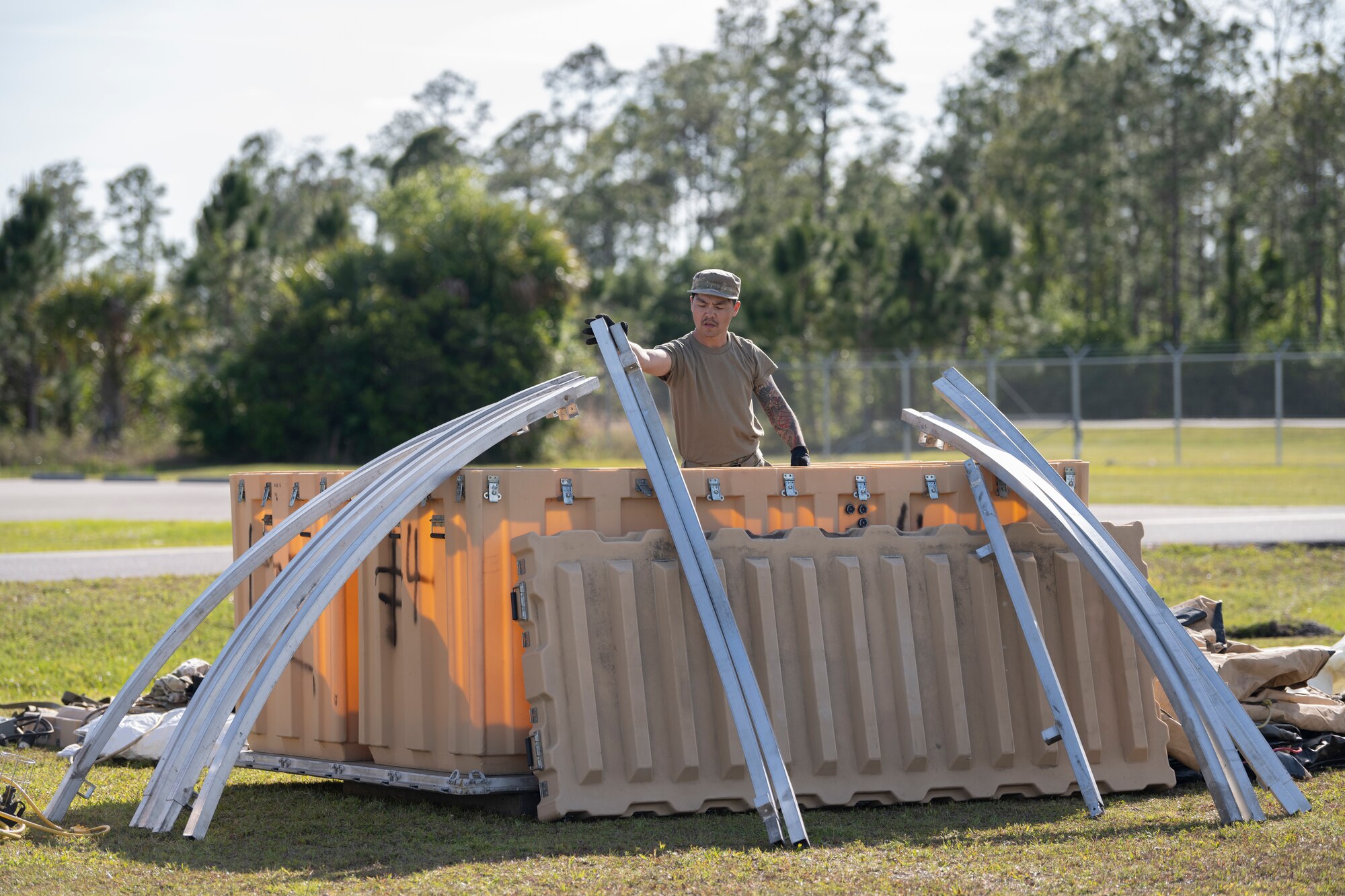 U.S. Air Force Airman 1st Class, Wenlong Wang, 23rd Civil Engineer Squadron structural apprentice, unloads a container at Avon Park Air Force Range, Florida, April 8, 2024. Airmen packaged shelters into transportable containers, ensuring swift deployment and seamless reassembly. Built upon Air Combat Command's directive to assert air power in contested environments, Exercise Ready Tiger 24-1 aims to test and enhance the 23rd Wing’s proficiency in executing Lead Wing and Expeditionary Air Base concepts through Agile Combat Employment and command and control operations. (U.S. Air Force photo by Senior Airman Rachel Coates)