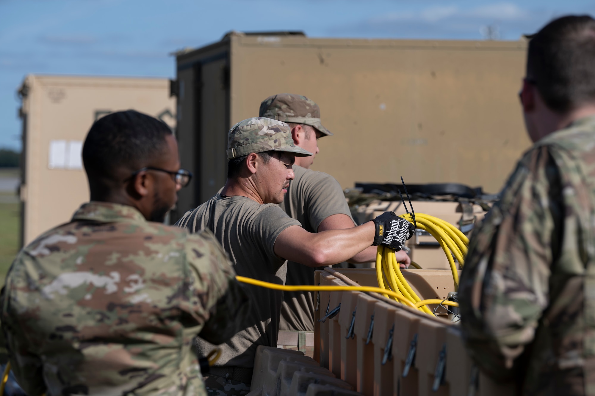 U.S. Air Force Airmen assigned to the 23rd Civil Engineer Squadron, grab a string of lights from a container at Avon Park Air Force Range, Florida, April 8, 2024. The Airmen established fortified shelters, complete with power infrastructure, enabling seamless operations in austere environmental conditions. Built upon Air Combat Command's directive to assert air power in contested environments, Exercise Ready Tiger 24-1 aims to test and enhance the 23rd Wing’s proficiency in executing Lead Wing and Expeditionary Air Base concepts through Agile Combat Employment and command and control operations. (U.S. Air Force photo by Senior Airman Rachel Coates)