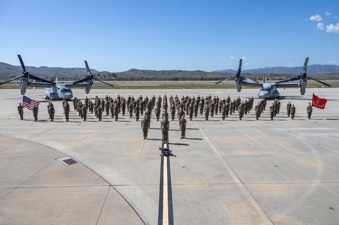 U.S. Marine Corps Sgt. Maj. Christopher Futch, left, the sergeant major, Lt. Col. John Miller, center, the commanding officer, Maj. Willis Woods, right, the executive officer, all of Marine Medium Tiltrotor Squadron (VMM) 364, Marine Aircraft Group 39, 3rd Marine Aircraft Wing, Marine Corps Air Station Camp Pendleton pose for a squadron photo at Marine Corps Air Station Camp Pendleton, California, April 8, 2024. (U.S. Marine Corps photo by Lance Cpl. Watts)