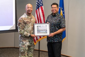 Col. Randel Gordon, Arnold Engineering Development Complex commander, presents Delvin Johnson, Alabama-Coushatta Tribe of Texas tribal representative, with a commemorative print by AEDC alum Don Northcutt during the 2024 Tribal Consultation, March 6 at the Gossick Leadership Center at Arnold Air Force Base, Tenn. (U.S. Air Force photo by Keith Thornburgh)