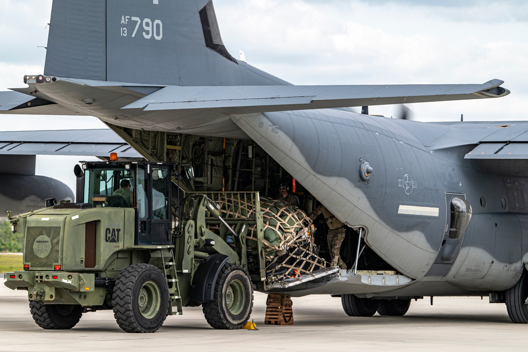 U.S. Air Force Airmen assigned to 23rd Logistics Readiness Squadron pick up cargo from an HC-130J Combat King II at Avon Park Air Force Range, Florida, for exercise Ready Tiger 24-1, April 9, 2024. Airmen deploying to austere locations must quickly and rapidly bring essential supplies and equipment to ensure mission success.  (U.S. Air Force photo by Airman 1st Class Leonid Soubbotine)