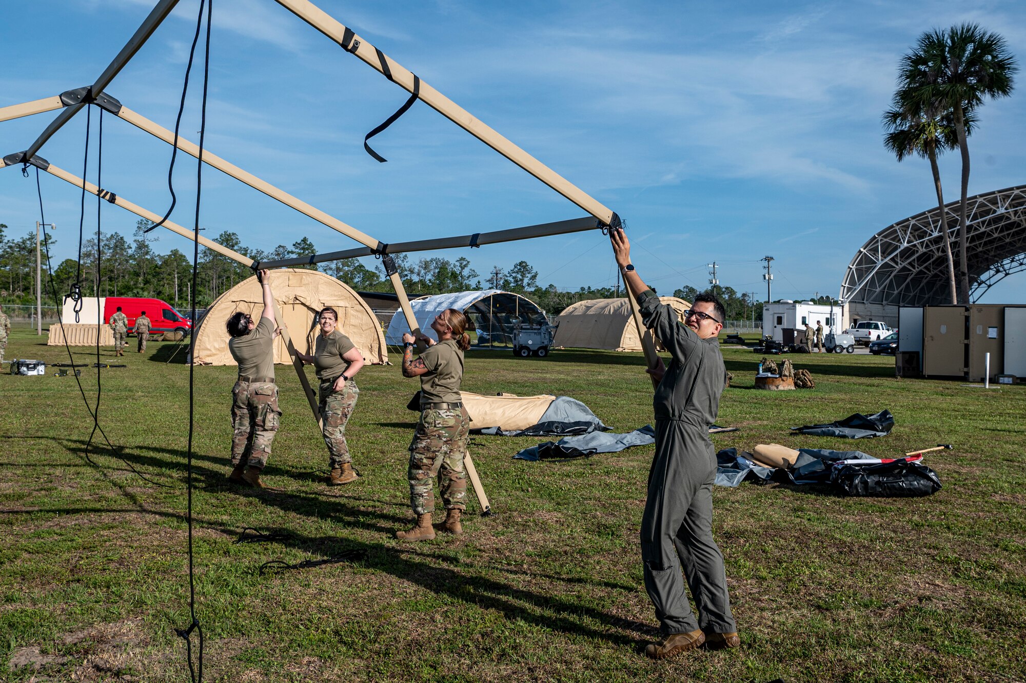 U.S. Air Force Airmen assigned to the 23rd Medical Group build a tent at Avon Park Air Force Range, Florida, April 9, 2024. Access to medical care in an austere environment is crucial to ensure the health and safety of Airmen. (U.S. Air Force photo by Airman 1st Class Leonid Soubbotine)