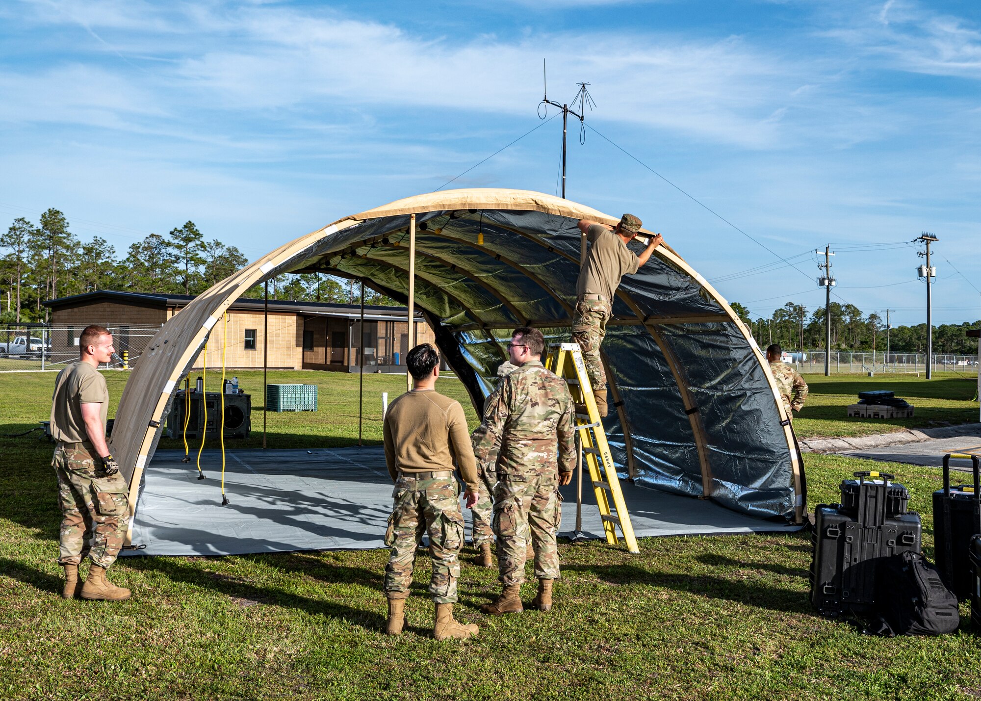U.S. Air Force Airmen assigned to the 23rd Logistics Readiness Squadron build a tent at Avon Park Air Force Range, Florida, April 9, 2024. Airmen from various Air Force specialties built the tents to allow communications, medical, and maintenance to operate at the forward operating site as part of exercise Ready Tiger 24-1. (U.S. Air Force photo by Airman 1st Class Leonid Soubbotine)