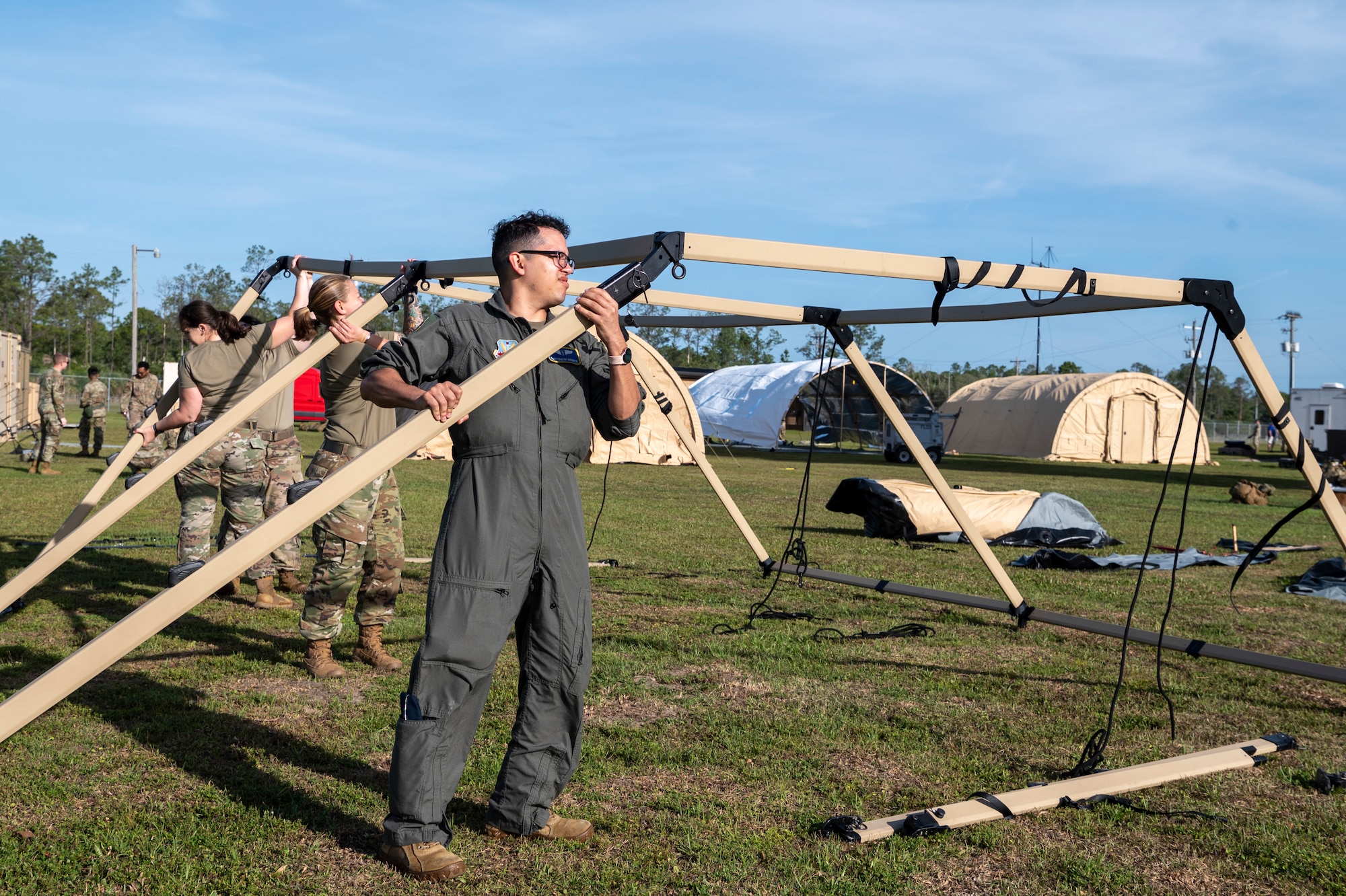 U.S. Air Force Airmen assigned to the 23rd Medical Group construct a medical shelter for exercise Ready Tiger 24-1 at Avon Park Air Force Range, Florida, April 9, 2024. Access to medical care in austere environments enables Airmen to receive medical care in expeditionary conditions. (U.S. Air Force photo by Airman 1st Class Leonid Soubbotine)