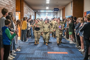 Airmen from Hill Air Force Base, Utah, parade through hallways filled with students and teachers from Syracuse Junior High School April 11, 2024, in Syracuse, Utah.