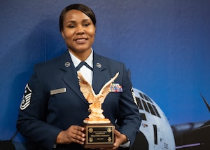 Female Airman standing with an award in her hands