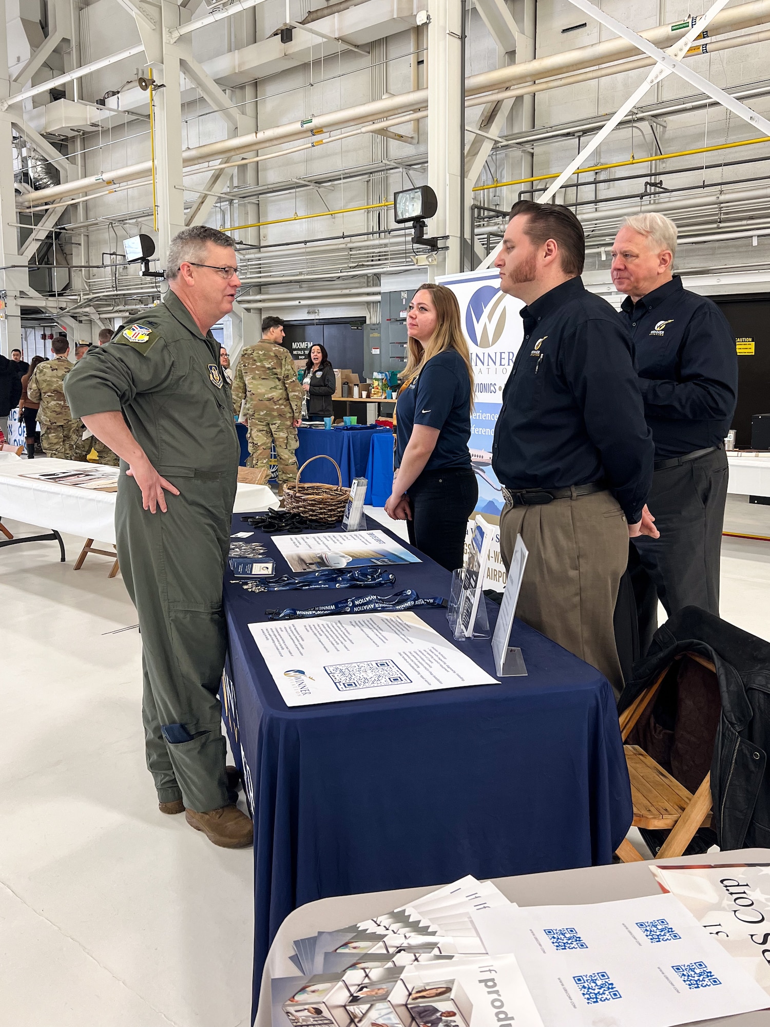 Col. Michael Maloney, 910th Airlift Wing commander, speaks with representatives from Winner Aviation during the 910th AW Career and Diversity Day, April 6, 2024, at Youngstown Air Reserve Station, Ohio.