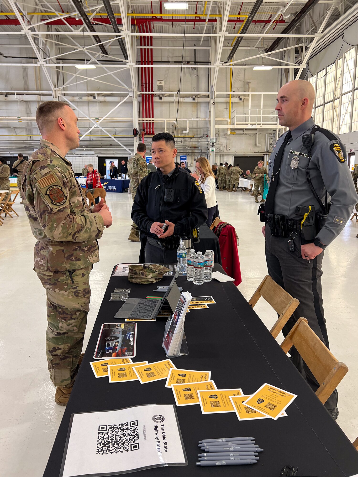 Master Sgt. Bradon Miller, 910th Civil Engineering Squadron member and Ohio State Highway Patrolman, discuss current job opportunities for Airmen during the 910th AW Career and Diversity Day, April 6, 2024, at Youngstown Air Reserve Station, Ohio.