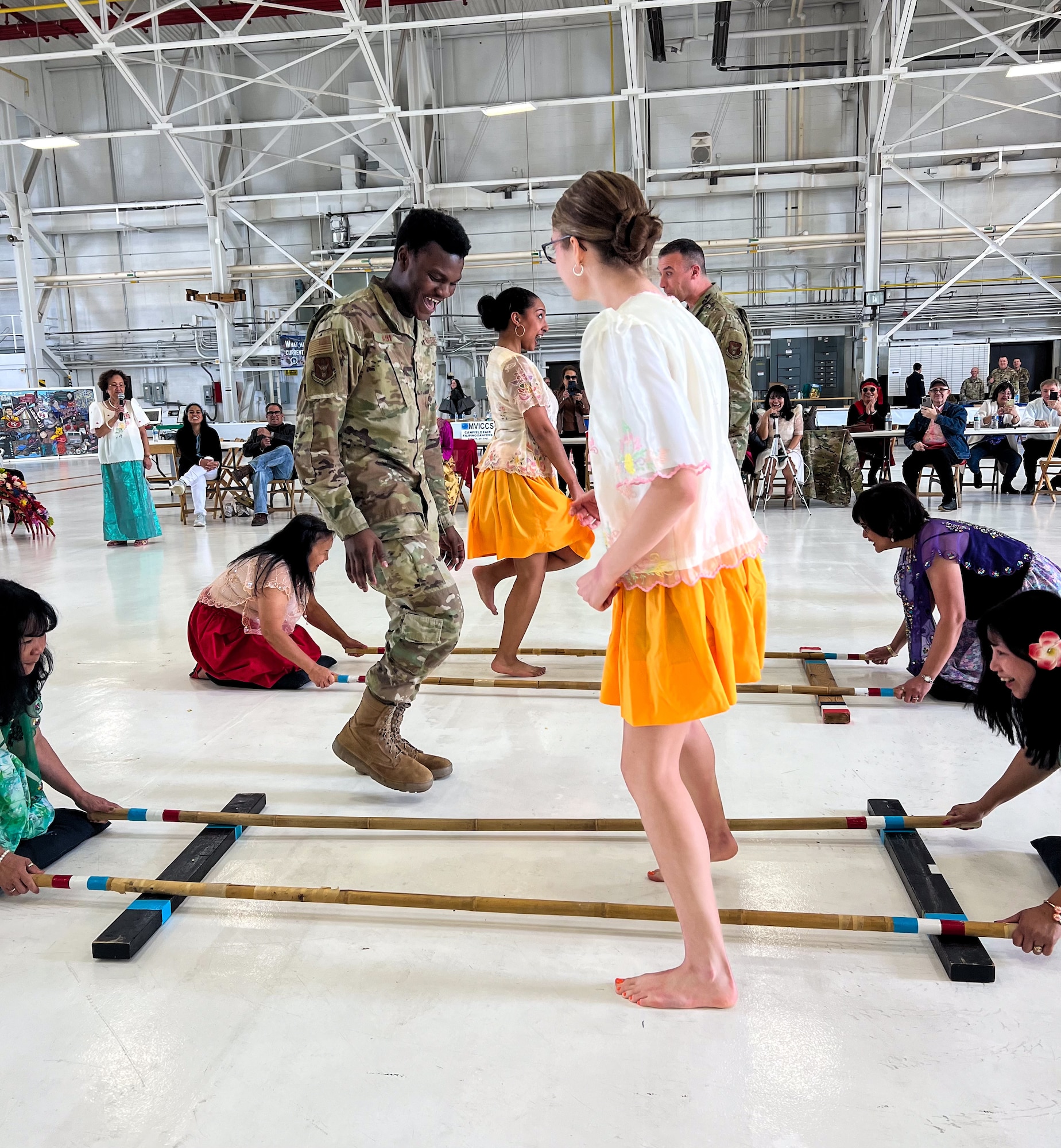 Members of the Filipino-American Organization of Northeast Ohio and 910th Airlift Wing Airmen perform the Tinikling, a Filipino folk dance, during the 910th Career and Diversity Day, April 6, 2024, at Youngstown Air Reserve Station, Ohio.