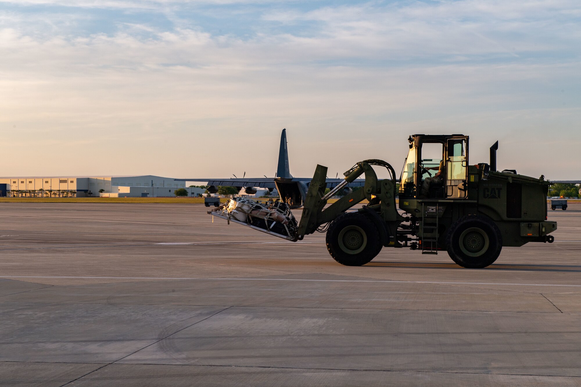 A U.S. Air Force Airman assigned to the 23rd Wing transports cargo from an aircraft during Exercise Ready Tiger  24-1 at Savannah Air National Guard Base, Georgia, April 8, 2024. The exercise was designed to test the 23rd Wing’s preparedness, specifically focusing on their ability to rapidly deploy and sustain operations in austere environments. The Ready Tiger 24-1 exercise evaluators will assess the 23rd Wing's proficiency in employing decentralized command and control to fulfill air tasking orders across geographically dispersed areas amid communication challenges. (U.S. Air Force photo by Senior Airman Courtney Sebastianelli)
