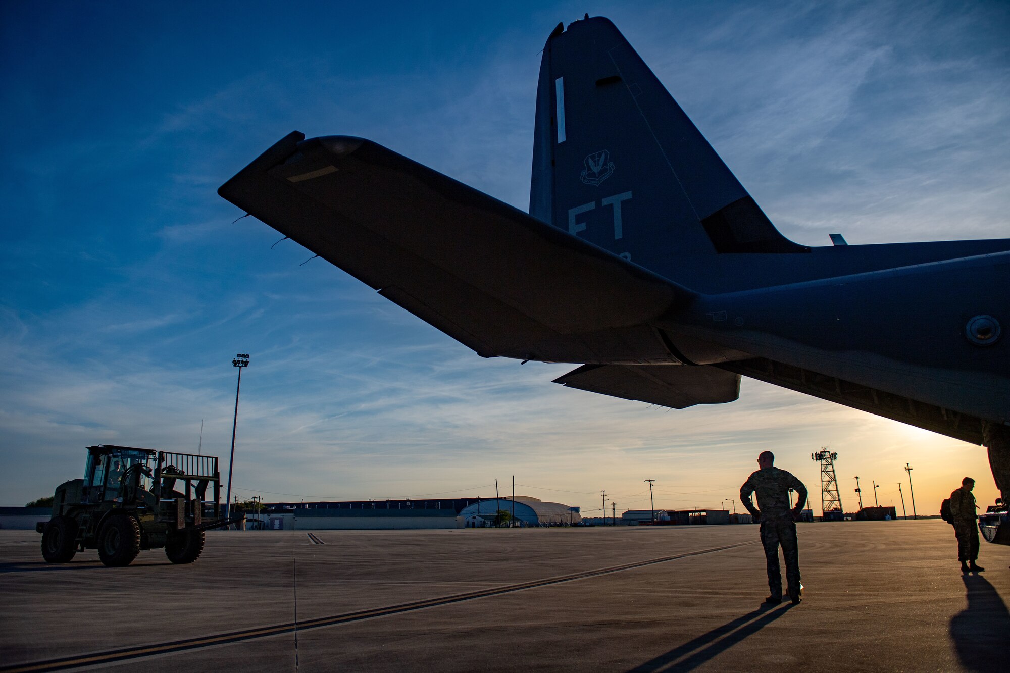 A U.S. Air Force Airman waits for a forklift to unload cargo from an HC-130J Combat King II assigned to the 71st Rescue Squadron during Exercise Ready Tiger 24-1 at Savannah Air National Guard Base, Georgia, April 8, 2024. The aircraft flew from Moody Air Force Base, Georgia to Savannah to set up a main operating base. Ready Tiger 24-1 is a readiness exercise demonstrating the 23rd Wing’s ability to plan, prepare and execute operations and maintenance to project air power in contested and dispersed locations, defending the United States’ interests and allies. (U.S. Air Force photo by Senior Airman Courtney Sebastianelli)