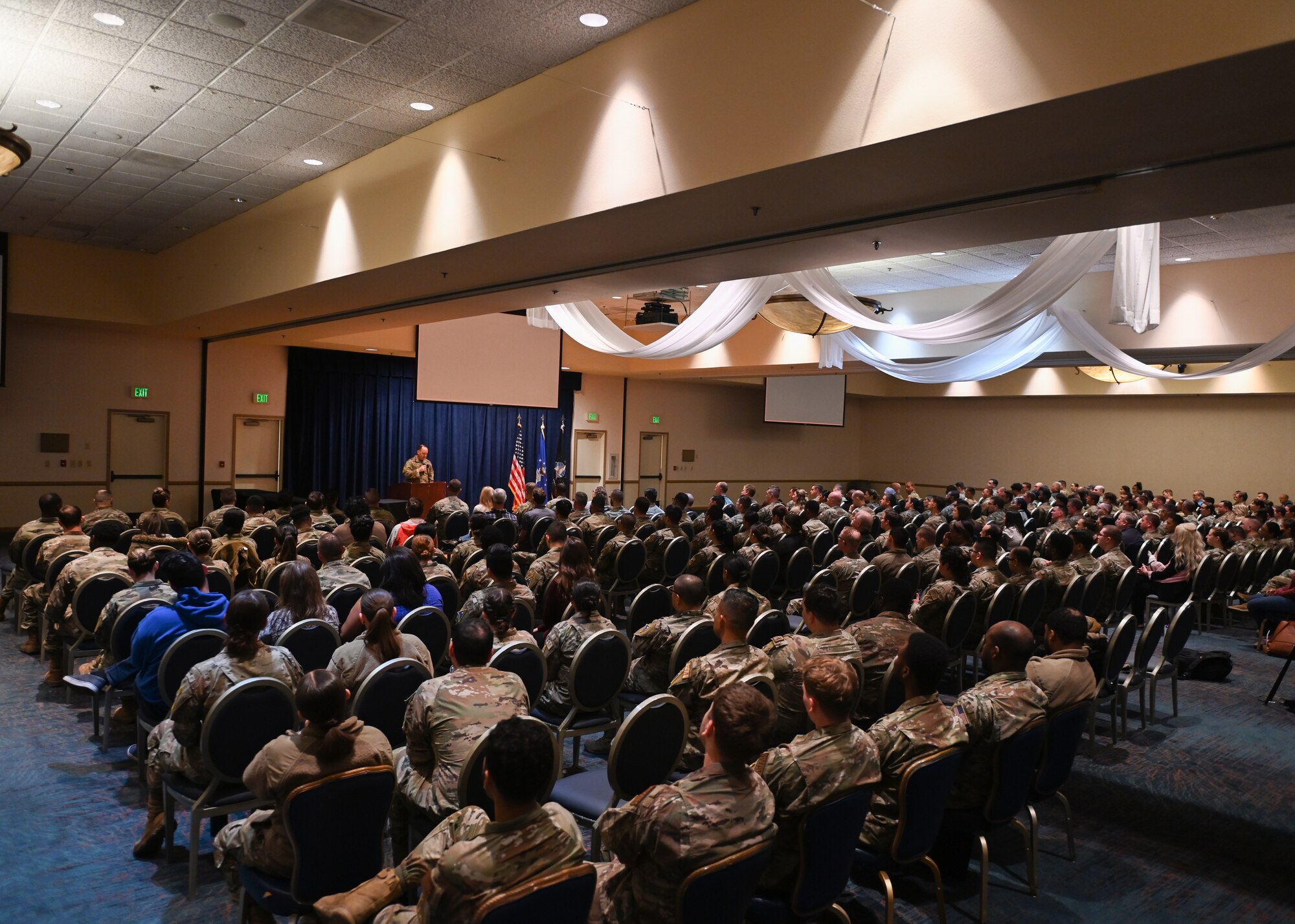 A group of people listen to a speaker.