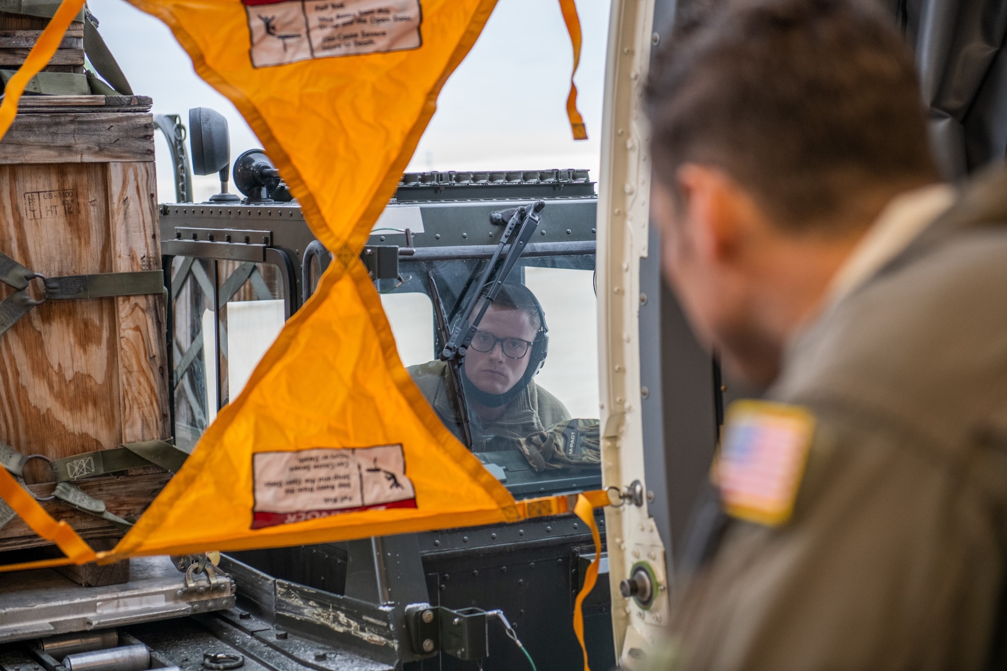 Tech. Sgt. Chris Davis, a boom operator from the 916th Air Refueling Wing, marshals Staff Sgt. Todd Rimmasch, an air transportation specialist in the 67th Aerial Port Squadron, in docking an aircraft cargo loader