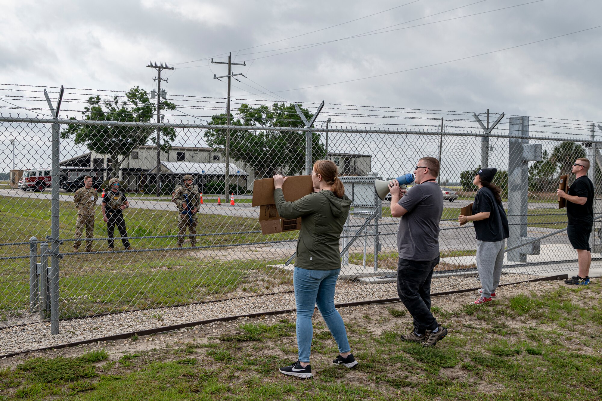 U.S. Air Force Airmen assigned to the 23rd Wing inspection team simulate a peaceful protest during Exercise Ready Tiger 24-1 at Avon Park Air Force Range, Florida, April 11, 2024. The protest was an added exercise scenario to increase preparedness and the ability to respond to potential threats. Ready Tiger 24-1 is a readiness exercise demonstrating the 23rd Wing’s ability to plan, prepare and execute operations and maintenance to project air power in contested and dispersed locations, defending the United States’ interests and allies. (U.S. Air Force photo by Airman 1st Class Leonid Soubbotine)