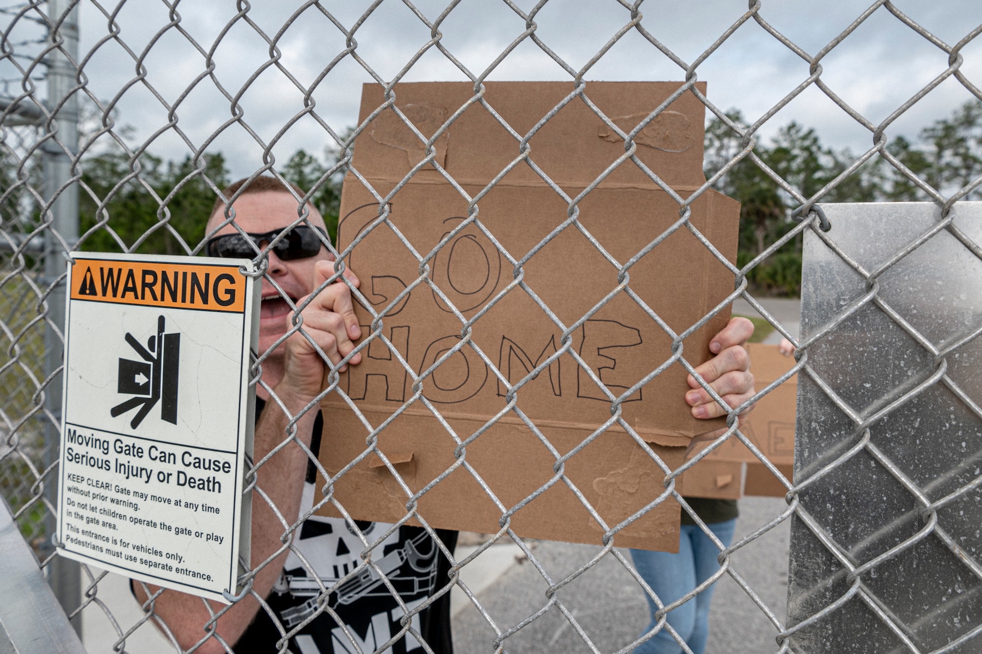 A U.S. Air Force Airman assigned to the 23rd Wing inspection team holds a simulated protest sign during Exercise Ready Tiger 24-1 at Avon Park Air Force Range, Florida, April 11, 2024. Moody Airmen were tested in their ability to stay calm under stress, which is essential for mission success. Built upon Air Combat Command's directive to assert air power in contested environments, Exercise Ready Tiger 24-1 aims to test and enhance the 23rd Wing’s proficiency in executing Lead Wing and Expeditionary Air Base concepts through Agile Combat Employment and command and control operations. (U.S. Air Force photo by Airman 1st Class Leonid Soubbotine)