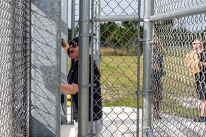 A U.S. Air Force Airman assigned to the 23rd Wing inspection team yells through a gate during Exercise Ready Tiger 24-1 at Avon Park Air Force Range, Florida, April 11, 2024. Inspectors yelled, used signs and loudspeakers to test the exercise participant’s response to a simulated peaceful protest. Built upon Air Combat Command's directive to assert air power in contested environments, Exercise Ready Tiger 24-1 aims to test and enhance the 23rd Wing’s proficiency in executing Lead Wing and Expeditionary Air Base concepts through Agile Combat Employment and command and control operations. (U.S. Air Force photo by Airman 1st Class Leonid Soubbotine)