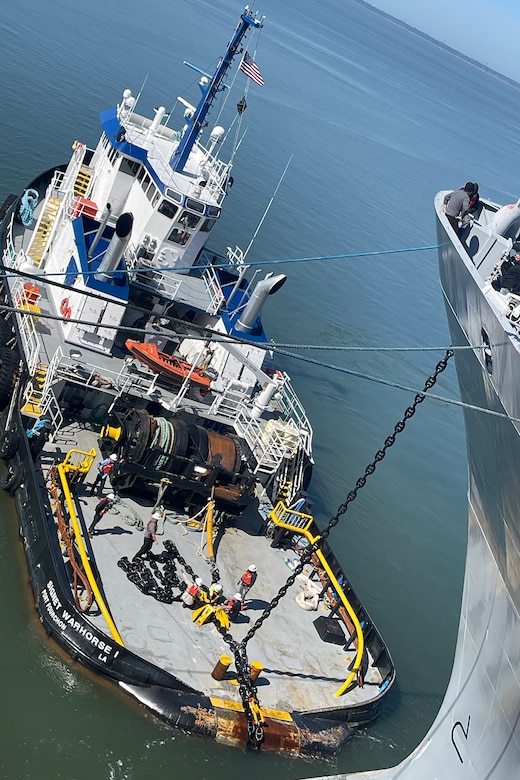 A tug tows a ship.