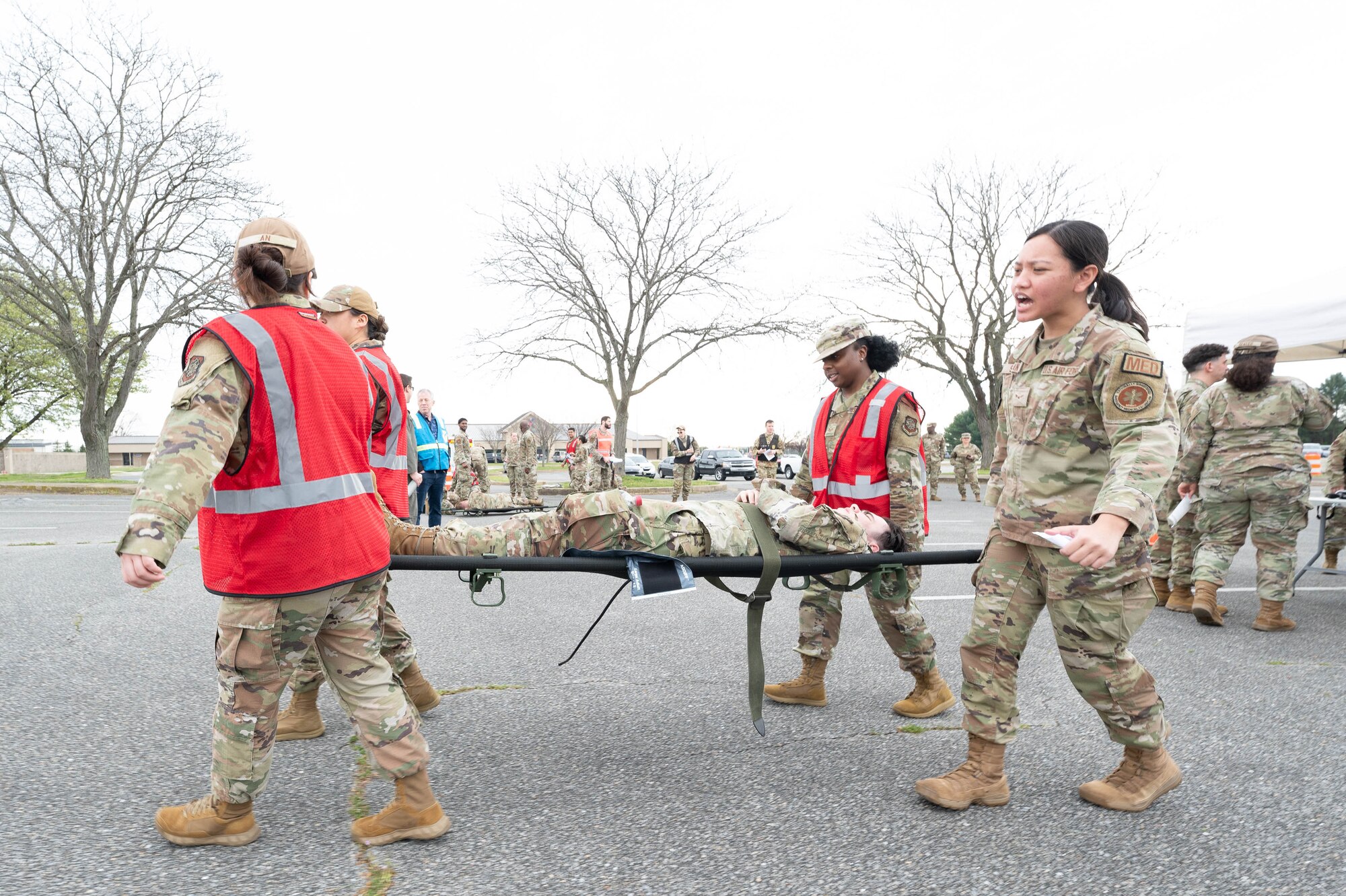 U.S. Air Force Airman 1st Class Angell St. Anna, 436th Health Care Operations Squadron medical technician, commands a litter team during a major accident response exercise at Dover Air Force Base, Delaware, April 10, 2024. The 436th Medical Group conducted the MARE featuring various medical and mental health emergencies in preparation for the upcoming air show. (U.S. Air Force photo by Mauricio Campino)