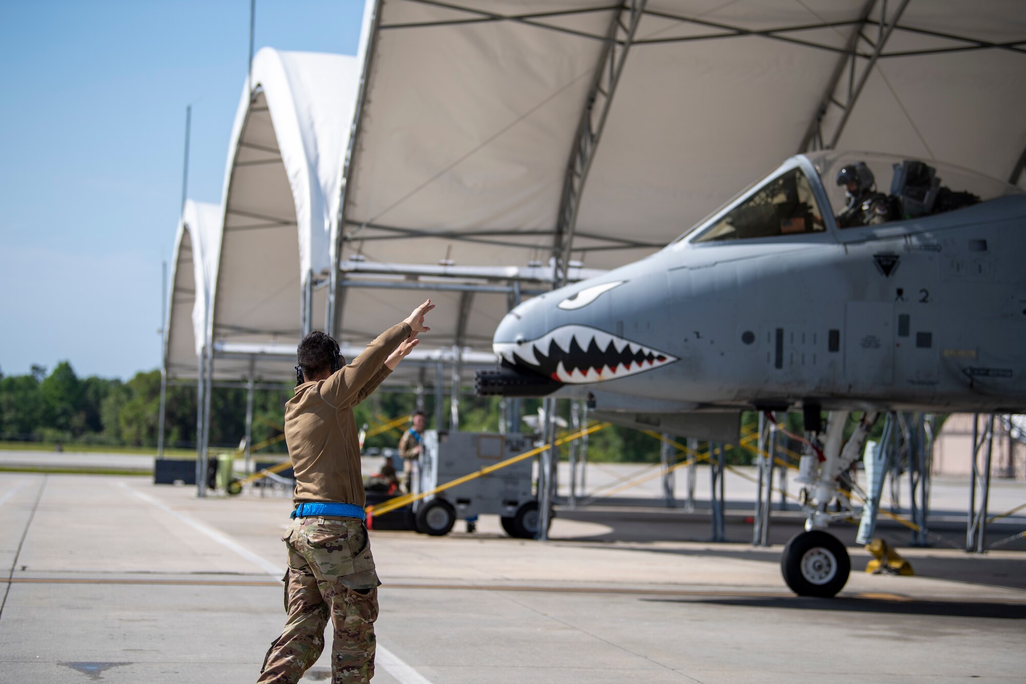 A U.S. Air Force crew chief assigned to the 23rd Maintenance Group marshals an A-10C Thunderbolt II during Exercise Ready Tiger 24-1 at Moody Air Force Base, Georgia, April 9, 2024. Crew chiefs perform various responsibilities, including conducting routine preventative and scheduled maintenance procedures, analyzing and maintaining computer-based programs, supervising teams, conducting technical inspections, and performing launch, recovery, and turnaround operations. During Ready Tiger 24-1, the 23rd Wing will be evaluated on the integration of Air Force Force Generation principles such as Agile Combat Employment, integrated combat turns, forward aerial refueling points, multi-capable Airmen, and combat search and rescue capabilities. (U.S. Air Force photo by 2nd Lt. Benjamin Williams)