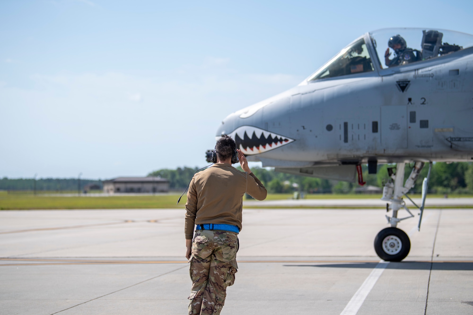 A U.S. Air Force crew chief assigned to the 23rd Maintenance Group salutes an A-10C Thunderbolt II pilot during Exercise Ready Tiger 24-1 at Moody Air Force Base, Georgia, April 9, 2024. Crew chiefs perform various responsibilities, including conducting routine preventative and scheduled maintenance procedures, analyzing and maintaining computer-based programs, supervising teams, conducting technical inspections, and performing launch, recovery, and turnaround operations. The Ready Tiger 24-1 exercise evaluators will assess the 23rd Wing's proficiency in employing decentralized command and control to fulfil air tasking orders across geographically dispersed areas amid communication challenges. (U.S. Air Force photo by 2nd Lt. Benjamin Williams).