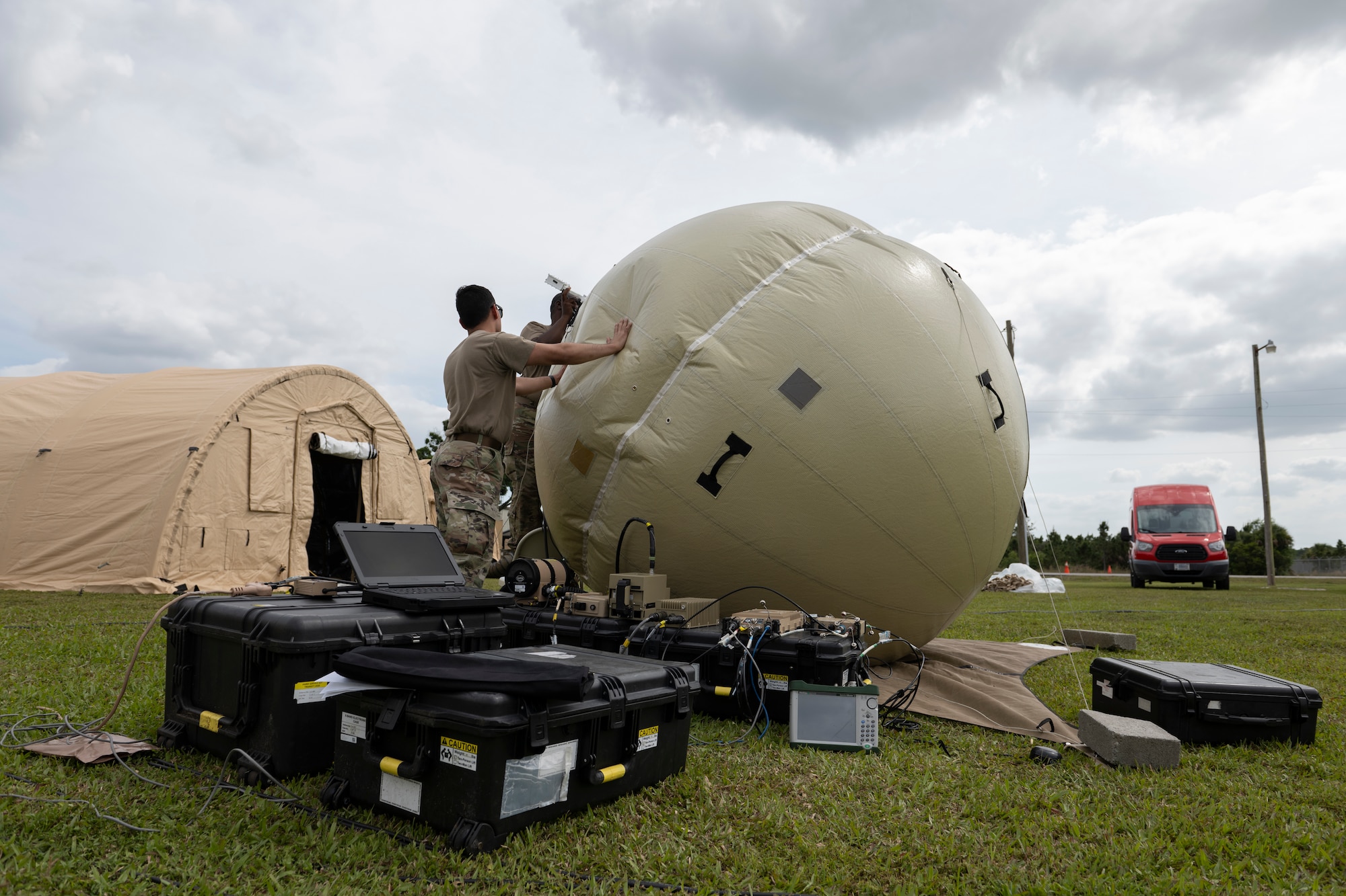 U.S. Air Force Airmen assigned to the 51st Combat Communications Squadron assemble a ground antenna transmit and receive (GATR) ball at Avon Park Air Force Range, Florida, April 9, 2024. The GATR ball was used during Exercise Ready Tiger 24-1 to provide personnel at Avon Park with Secret Internet Protocol Router network and Non-classified Internet Protocol Router network capabilities. The Ready Tiger 24-1 exercise evaluators will assess the 23rd Wing's proficiency in employing decentralized command and control to fulfill air tasking orders across geographically dispersed areas amid communication challenges. (U.S. Air Force photo by Senior Airman Rachel Coates)