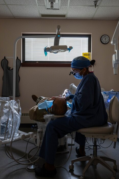 U.S. Air Force Master Sgt. Victoria Castaneda, 354th Operational Medical Readiness Squadron chief of preventive dentistry, conducts a teeth cleaning on a patient at Eielson Air Force Base, Alaska, April 3, 2024.