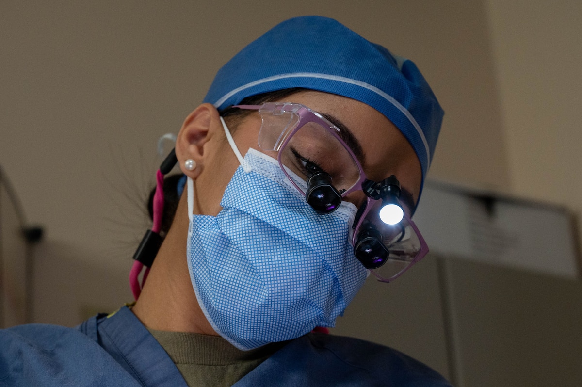 U.S. Air Force Master Sgt. Victoria Castaneda, 354th Operational Medical Readiness Squadron chief of preventive dentistry, conducts a teeth cleaning on a patient at Eielson Air Force Base, Alaska, April 3, 2024.