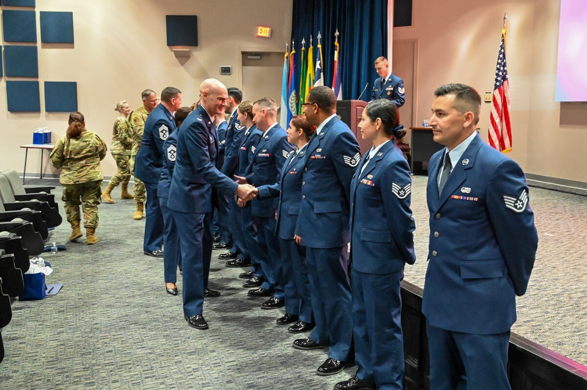 Col. William Gutermuth, 433rd Airlift Wing commander, congratulates a group of newly inducted Non-Commissioned Officers during an NCO Induction Ceremony at Joint Base San Antonio-Lackland, Texas on April 6, 2024.