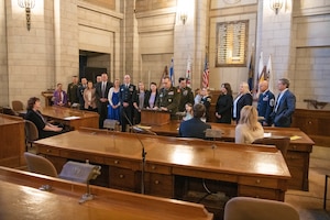 Large group of people gathering to take photo.