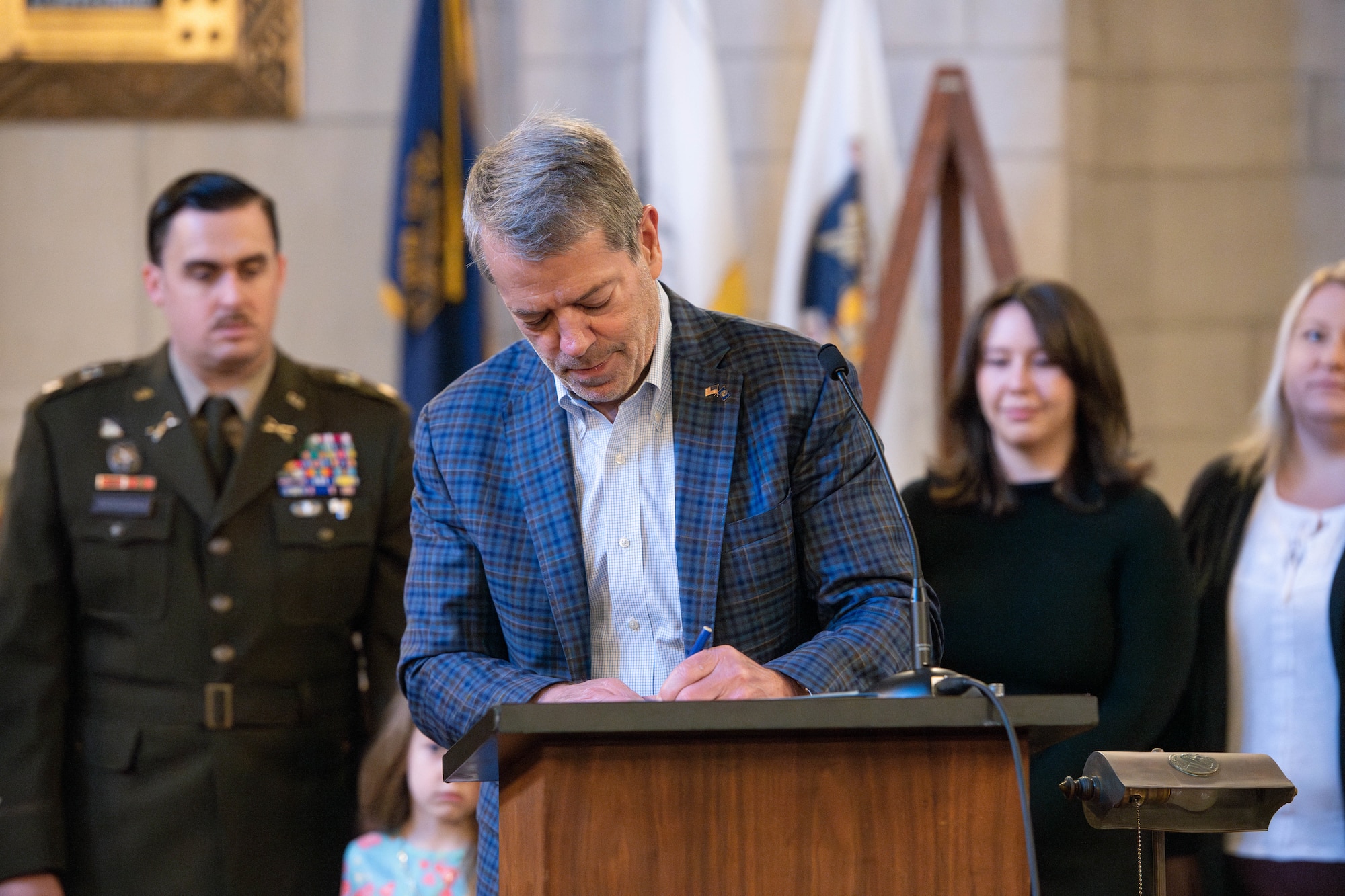 Male signing legal document.