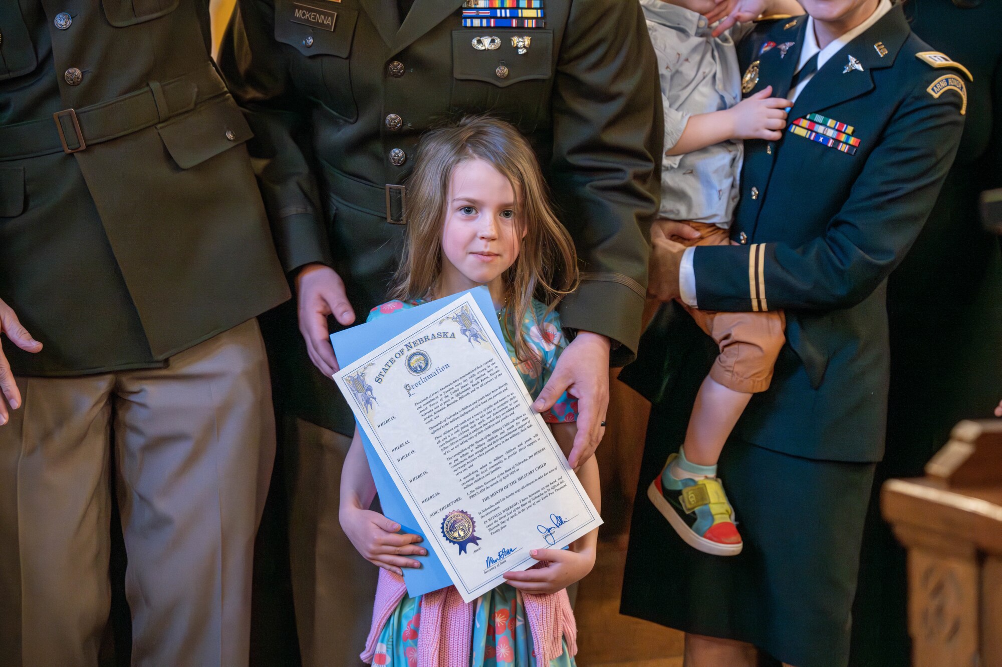 Small girl holding signed legal document.