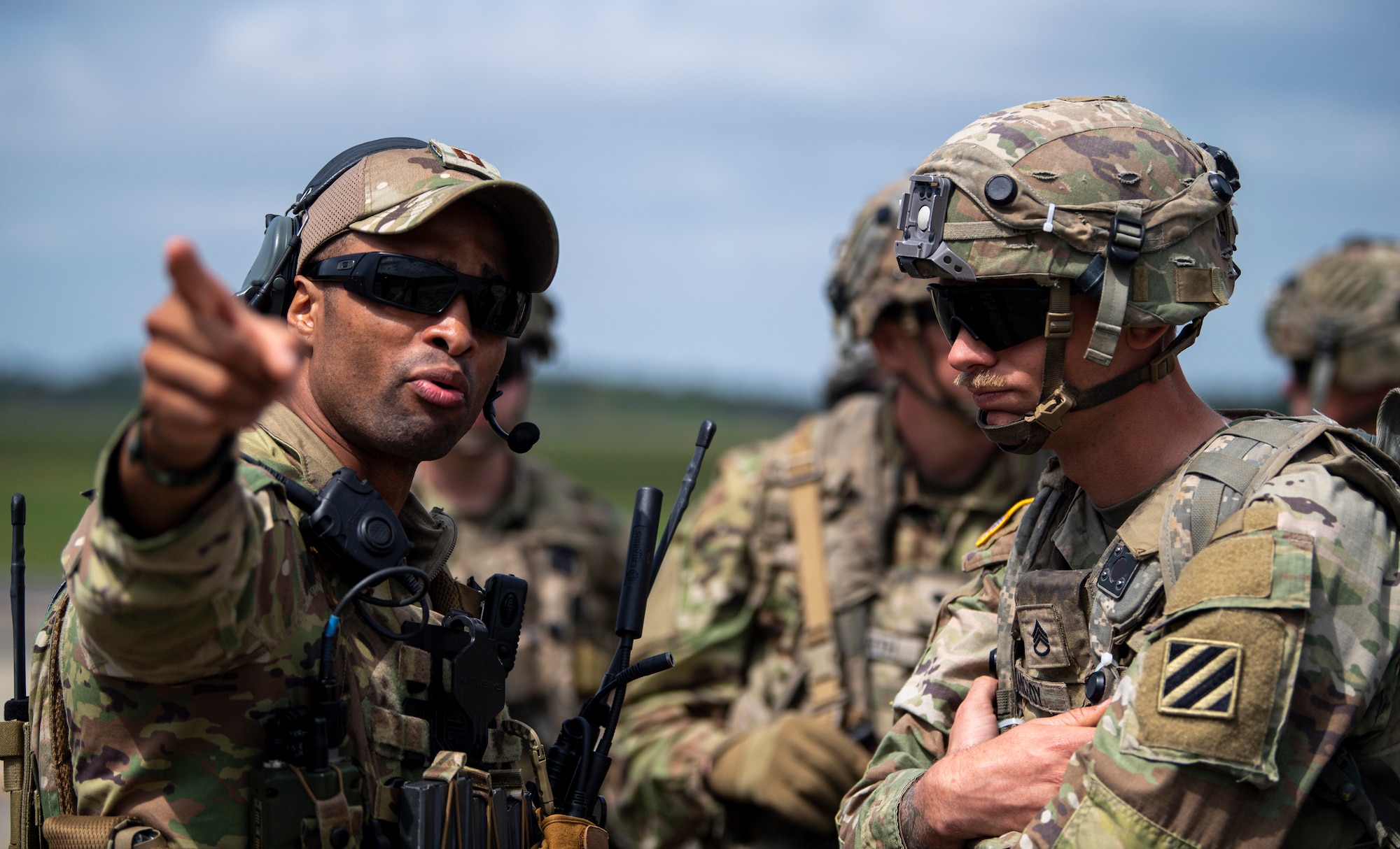 U.S. Air Force Capt. Marcos Marrero-Disla, a 621st Mobility Support Operations Squadron air mobility liason officer, speaks to a soldier with the 5th Squadron, 7th Cavalry Regiment during Exercise SWAMP AVENGER 24-2 at North Auxillary Field, South Carolina, April 2, 2024.