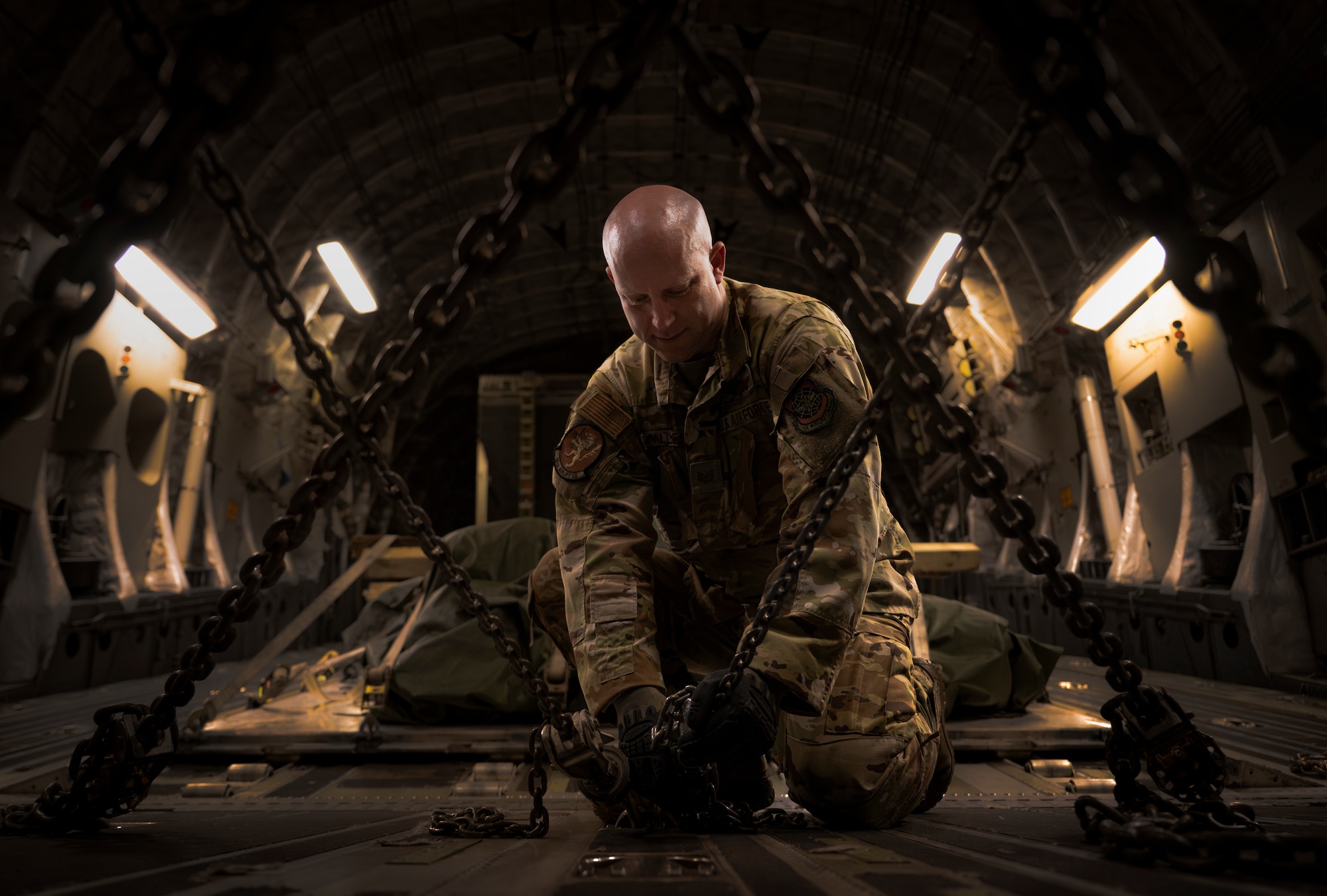 Tech. Sgt. Keith Allen, a 16th Airlift Squadron loadmaster, restrains a Bradley Fighting Vehicle during Exercise SWAMP AVENGER 24-2 at North Auxillary Field, South Carolina, April 3, 2024.