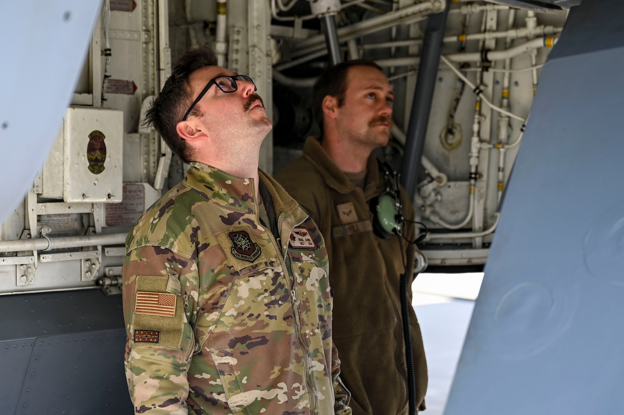 Airmen inspect aircraft