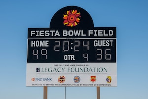 The Fiesta Bowl Field scoreboard stands over the new track and field during a ribbon cutting ceremony, April 11, 2024, at Luke Air Force Base, Arizona.