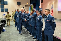Col. William Gutermuth, 433rd Airlift Wing commander, congratulates a group of newly inducted Non-Commissioned Officers during an NCO Induction Ceremony at Joint Base San Antonio-Lackland, Texas on April 6, 2024.