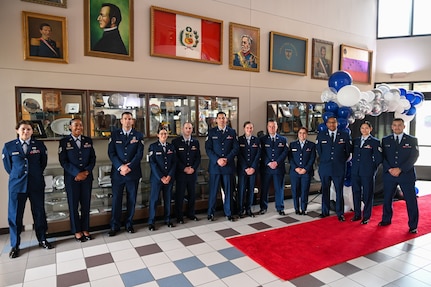 A group new 433rd Airlift Wing and 960th Cyberspace Wing Non-Commissioned Officers pose for a photo at the Inter-American Air Forces Academy Auditorium before an NCO Induction Ceremony on Joint Base San Antonio-Lackland, Texas on April 6, 2024.