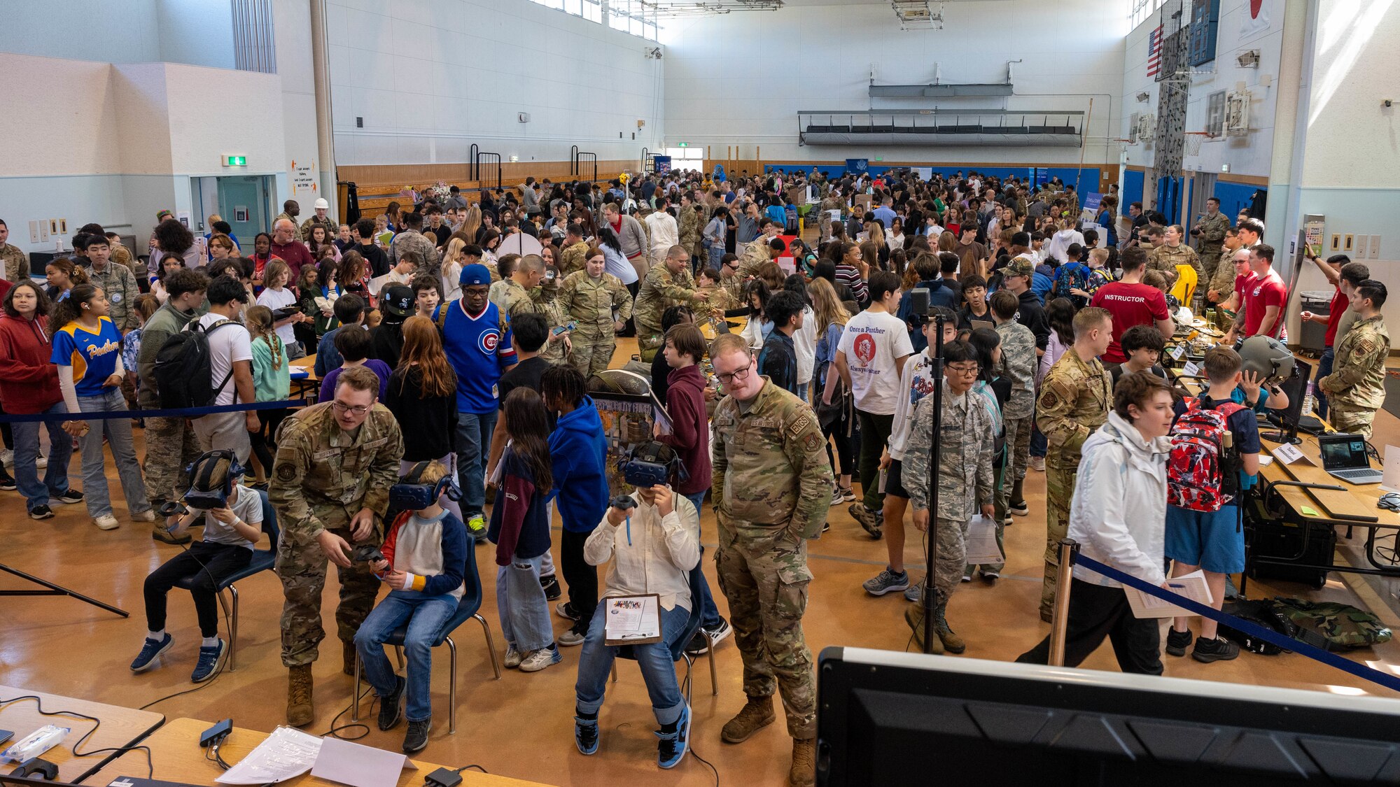 Photo of DoDEA students participating in a career fair involving U.S. Air Force Airmen and community partners.