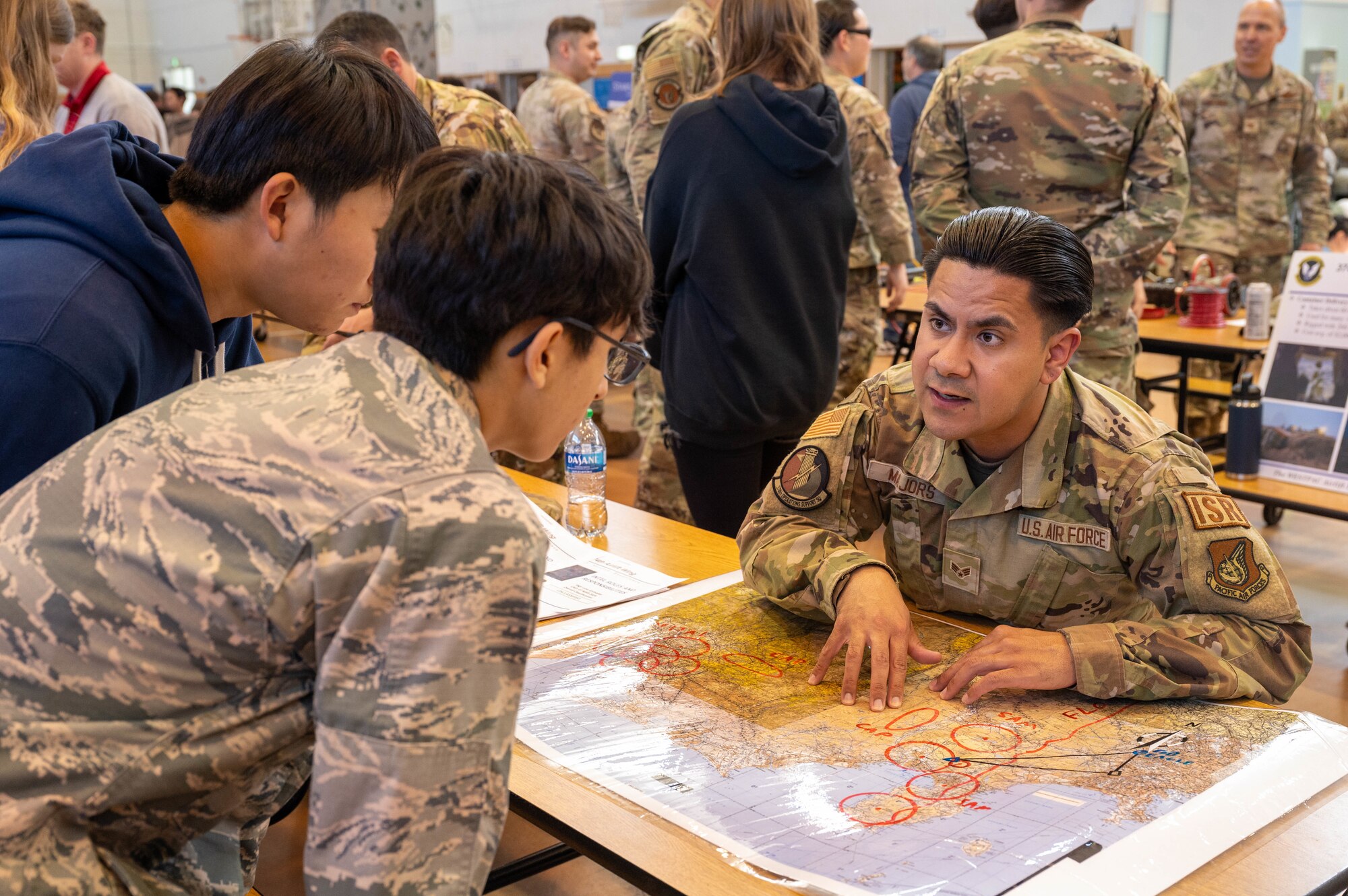 Photo of DoDEA students participating in a career fair involving U.S. Air Force Airmen and community partners.