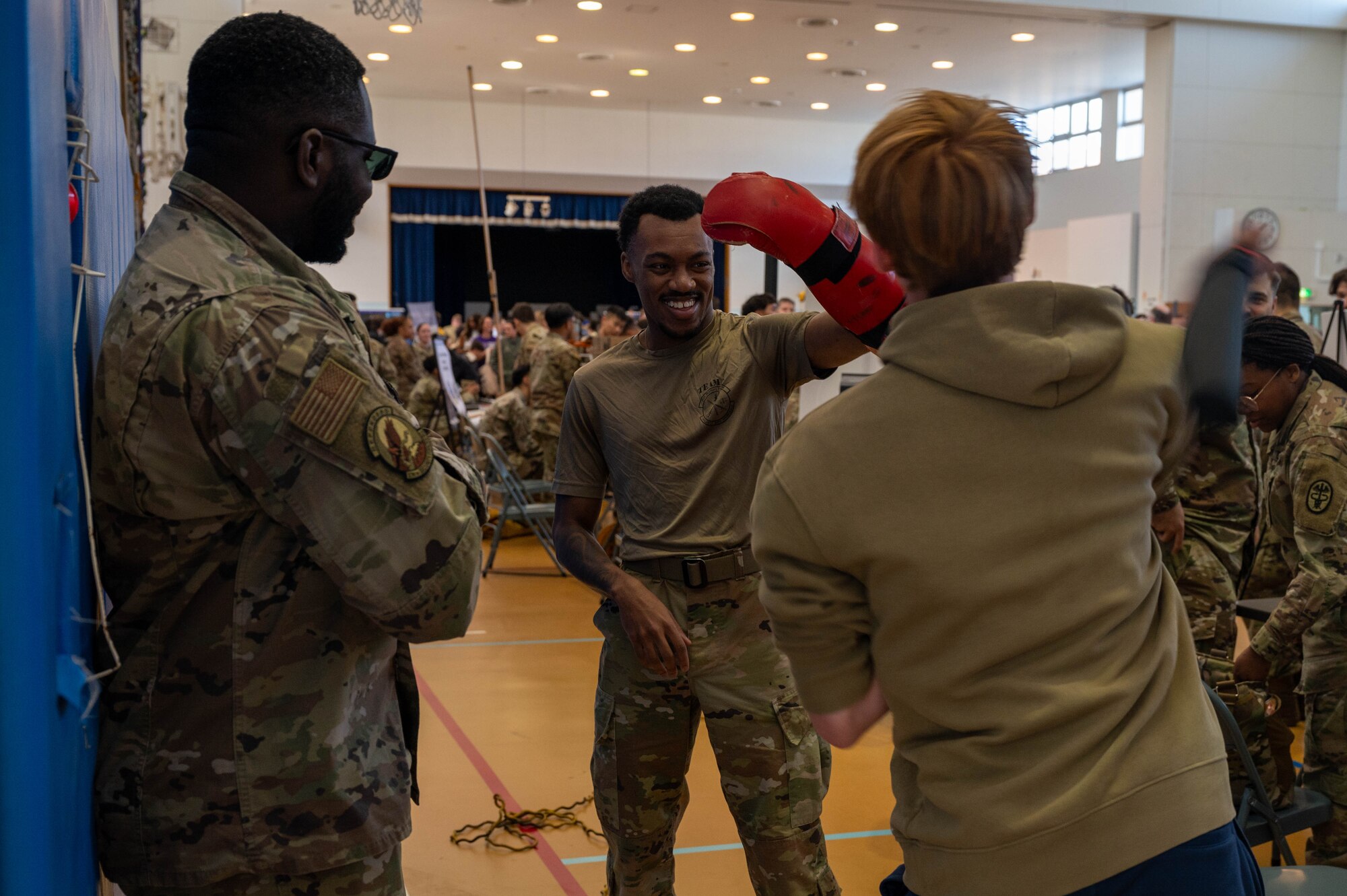 Photo of DoDEA students participating in a career fair involving U.S. Air Force Airmen and community partners.