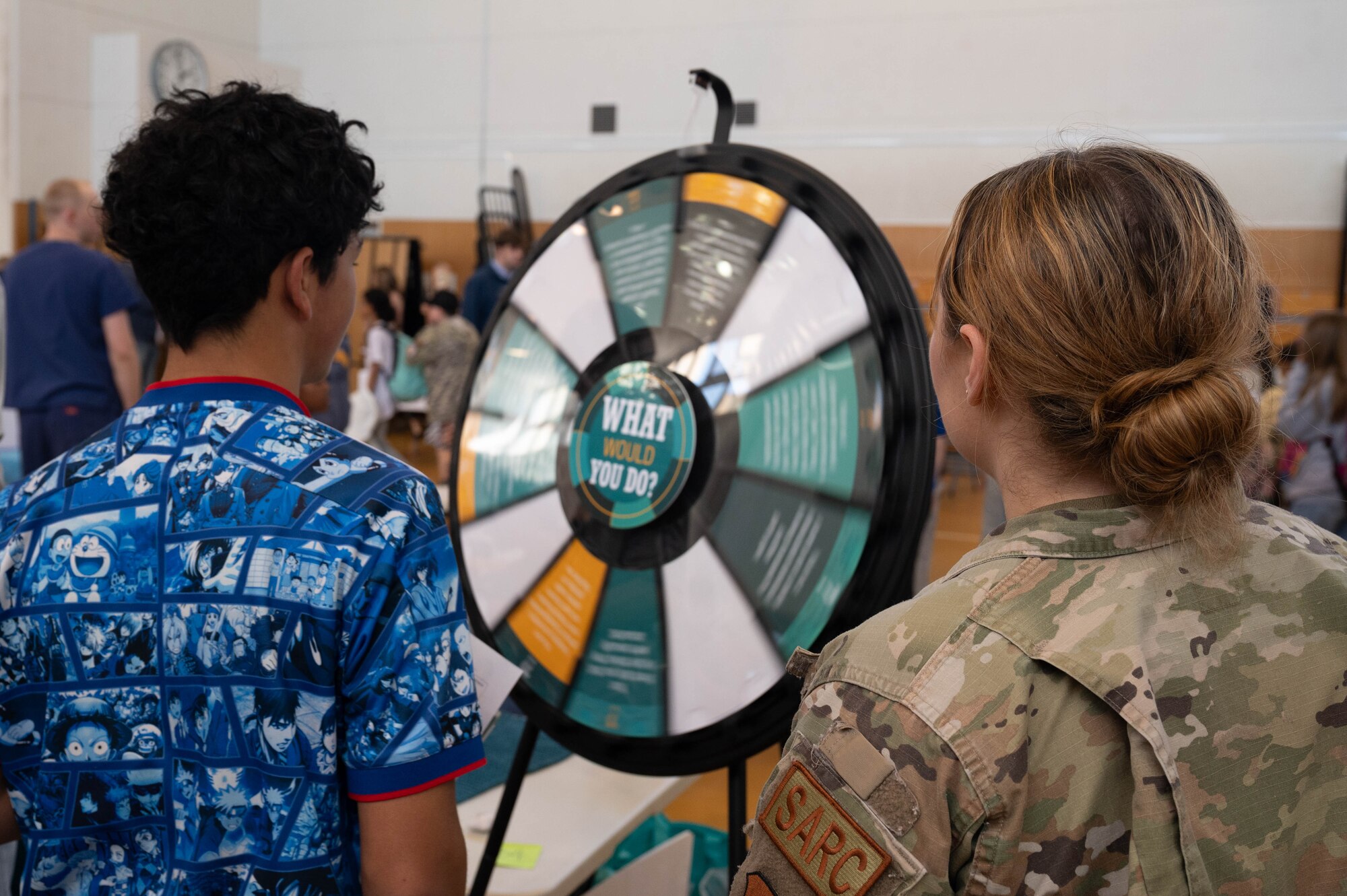 Photo of DoDEA students participating in a career fair involving U.S. Air Force Airmen and community partners.