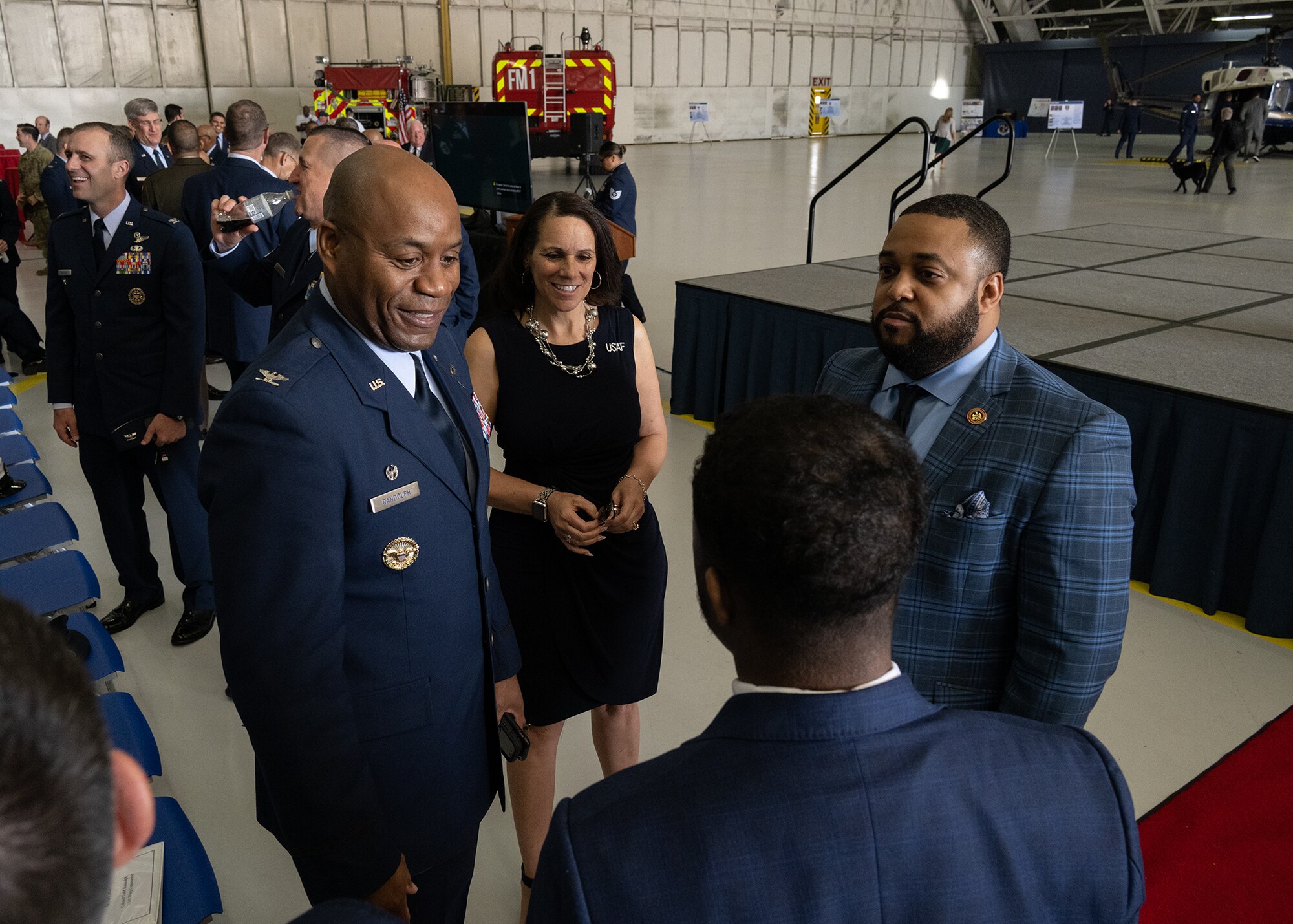 U.S. Air Force Col. Todd E. Randolph, 316th Wing and installation commander, left, his wife Mrs. Penny Randolph, center, and Maryland State Sen. Nick Charles speak with local community members at the Joint Base Andrews State of the Base Address, April 10, 2024.
