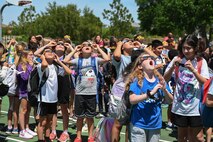 Students from the Tinker K-8 School at MacDill Air Force Base, Fla., watch the solar eclipse