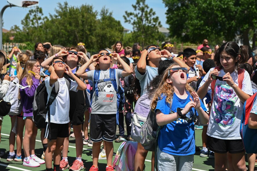 Students from the Tinker K-8 School at MacDill Air Force Base, Fla., watch the solar eclipse
