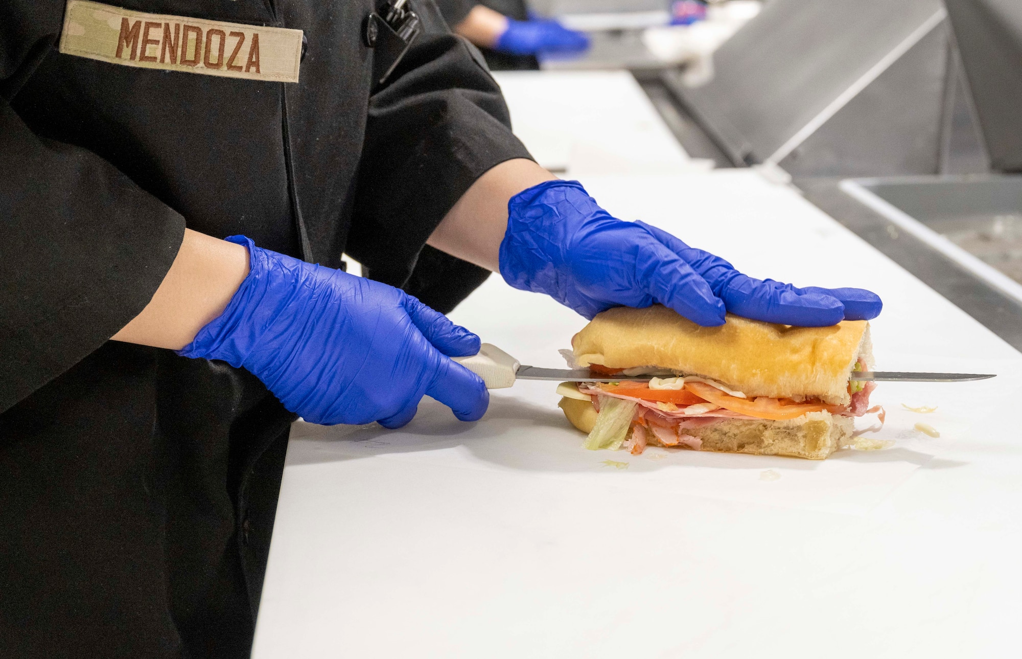 U.S. Air Force Airman Christina Mendoza, 49th Force Support Squadron food services journeyman, prepares a 49er Cafe sandwich during lunch at Holloman Air Force Base, New Mexico, March 27, 2024. The 49er Cafe recently unveiled a new menu featuring a selection of delectable breakfast and lunch items, along with coffee drinks for base personnel. (U.S. Air Force photo by Airman 1st Class Michelle Ferrari)
