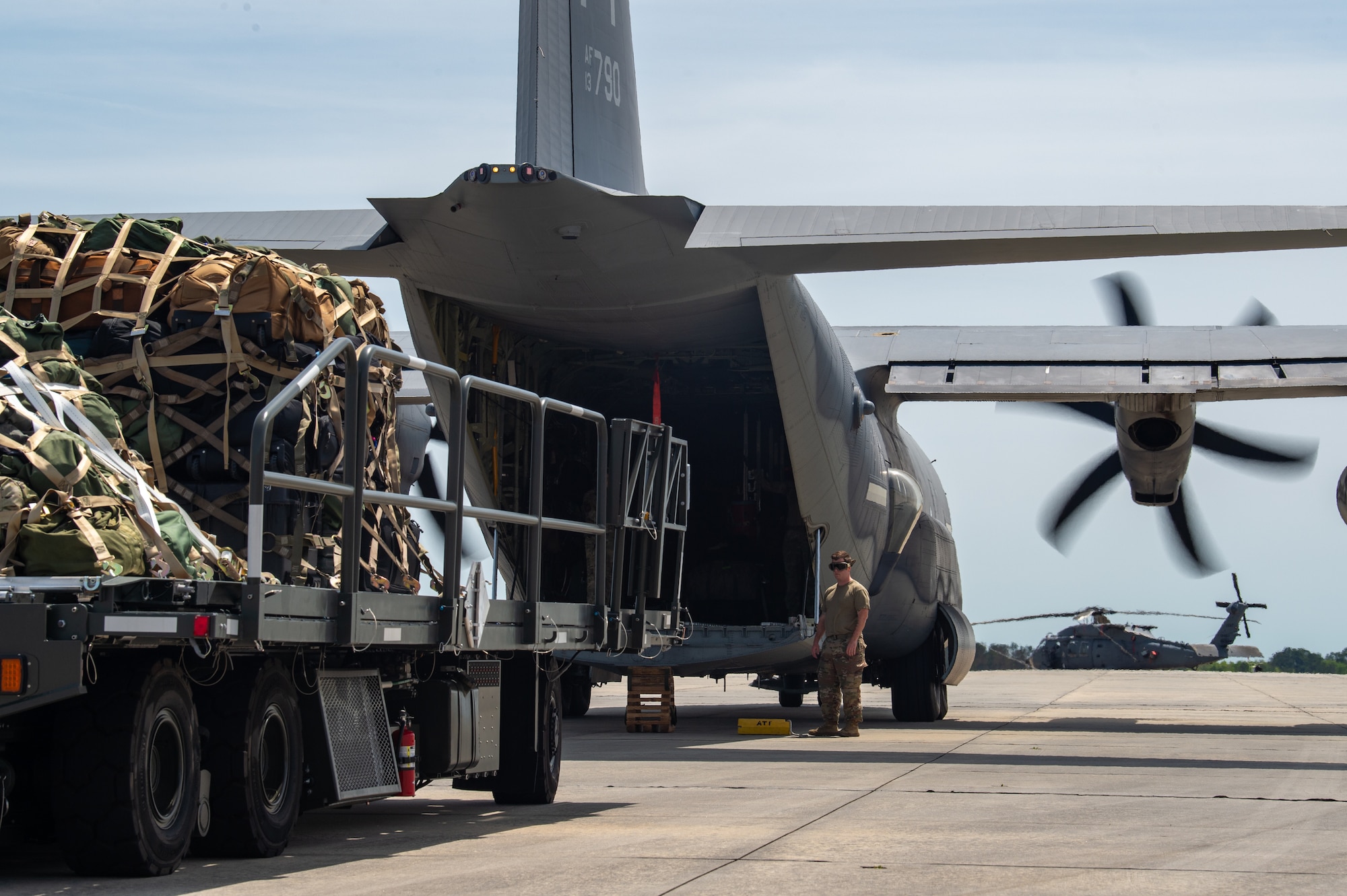 A U.S. Air Force Airman assigned to the 23rd Wing prepares to load luggage onto an HC-130J Combat King II in support of Exercise Ready Tiger at Moody Air Force Base, Georgia, April 8, 2024. The luggage was vital to the mission as it held the departing Airmen’s personal bags and equipment. Built upon Air Combat Command's directive to assert air power in contested environments, Exercise Ready Tiger 24-1 aims to test and enhance the 23rd Wing’s proficiency in executing Lead Wing and Expeditionary Air Base concepts through Agile Combat Employment and command and control operations. (U.S. Air Force photo by Airman 1st Class Iain Stanley)